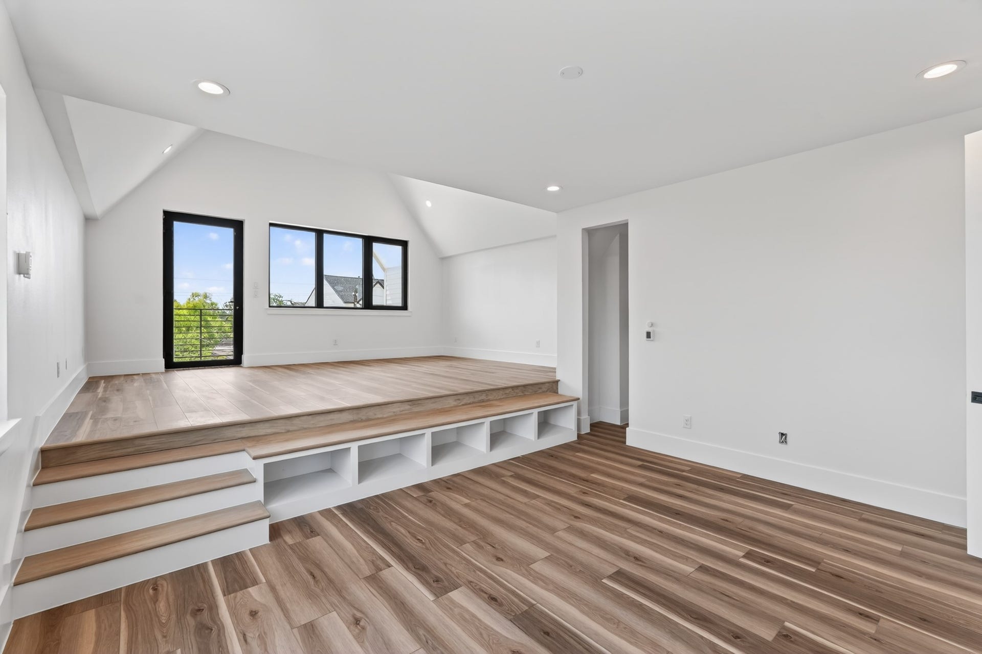 Unique primary suite occupying the entire third floor, featuring a split-level design with endless possibilities for a bedroom, private lounge, home theater, office, or fitness space. Filled with natural light and offering direct access to a private balcony.