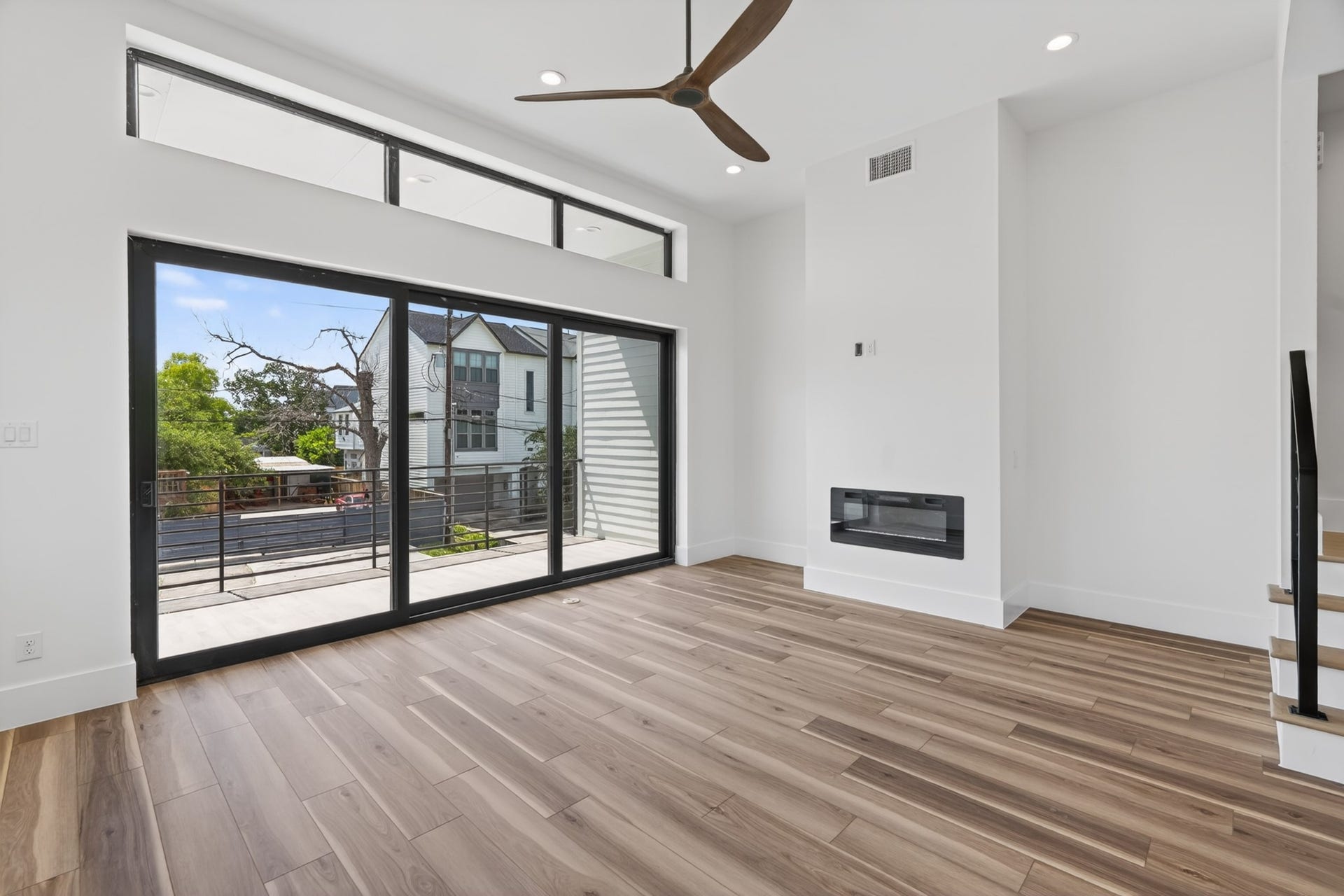 Premium European-style sliding doors open wide to blend the living room and balcony into one seamless entertaining space.