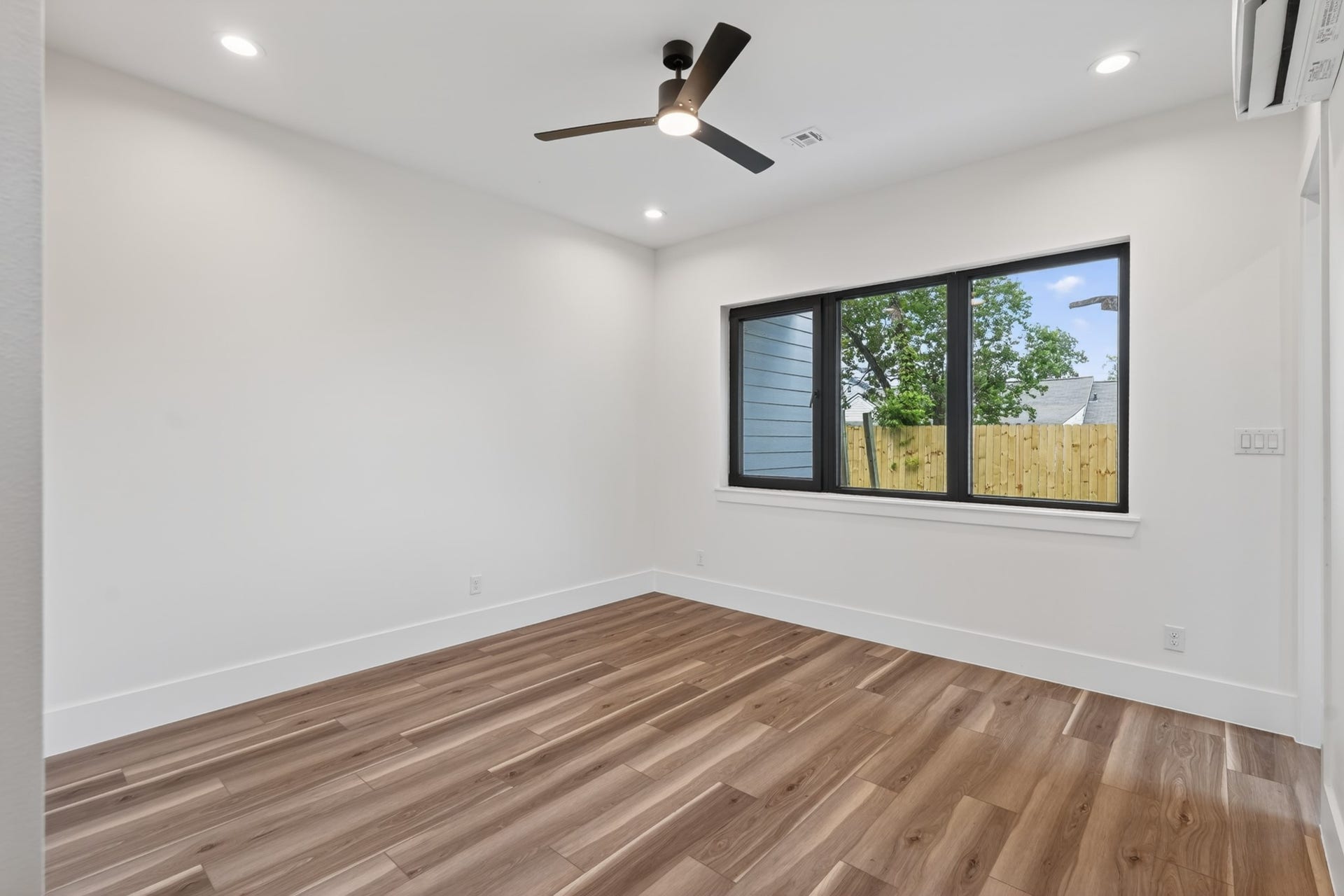 Comfortable guest bedroom with generous windows, ample closet space, and a versatile layout