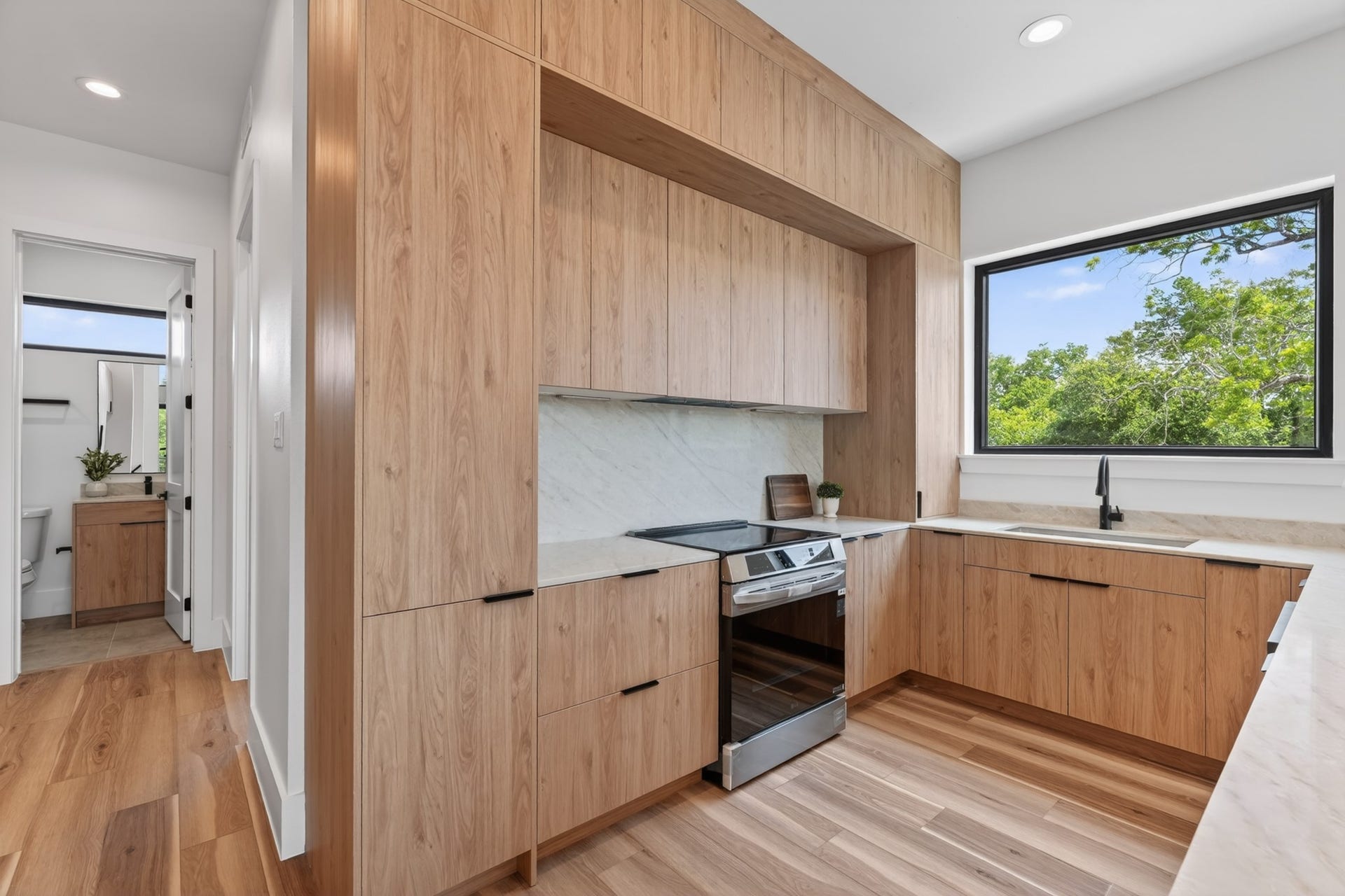 Modern kitchen with premium quartz countertops, minimalist European-inspired cabinetry, and a bright, open design perfect for entertaining.