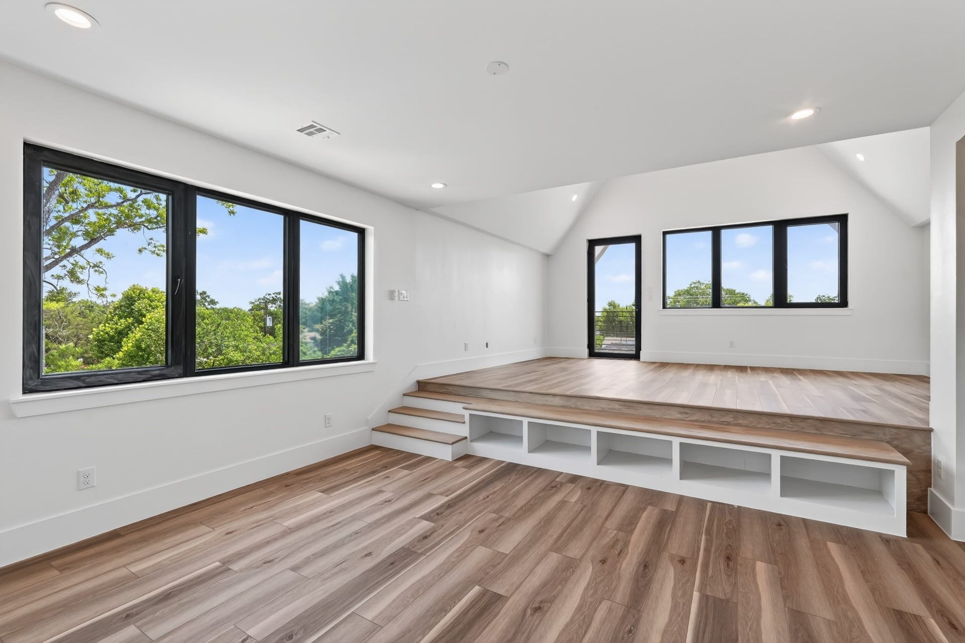 Unique primary suite occupying the entire third floor, featuring a split-level design with endless possibilities for a bedroom, private lounge, home theater, office, or fitness space. Filled with natural light and offering direct access to a private balcony.