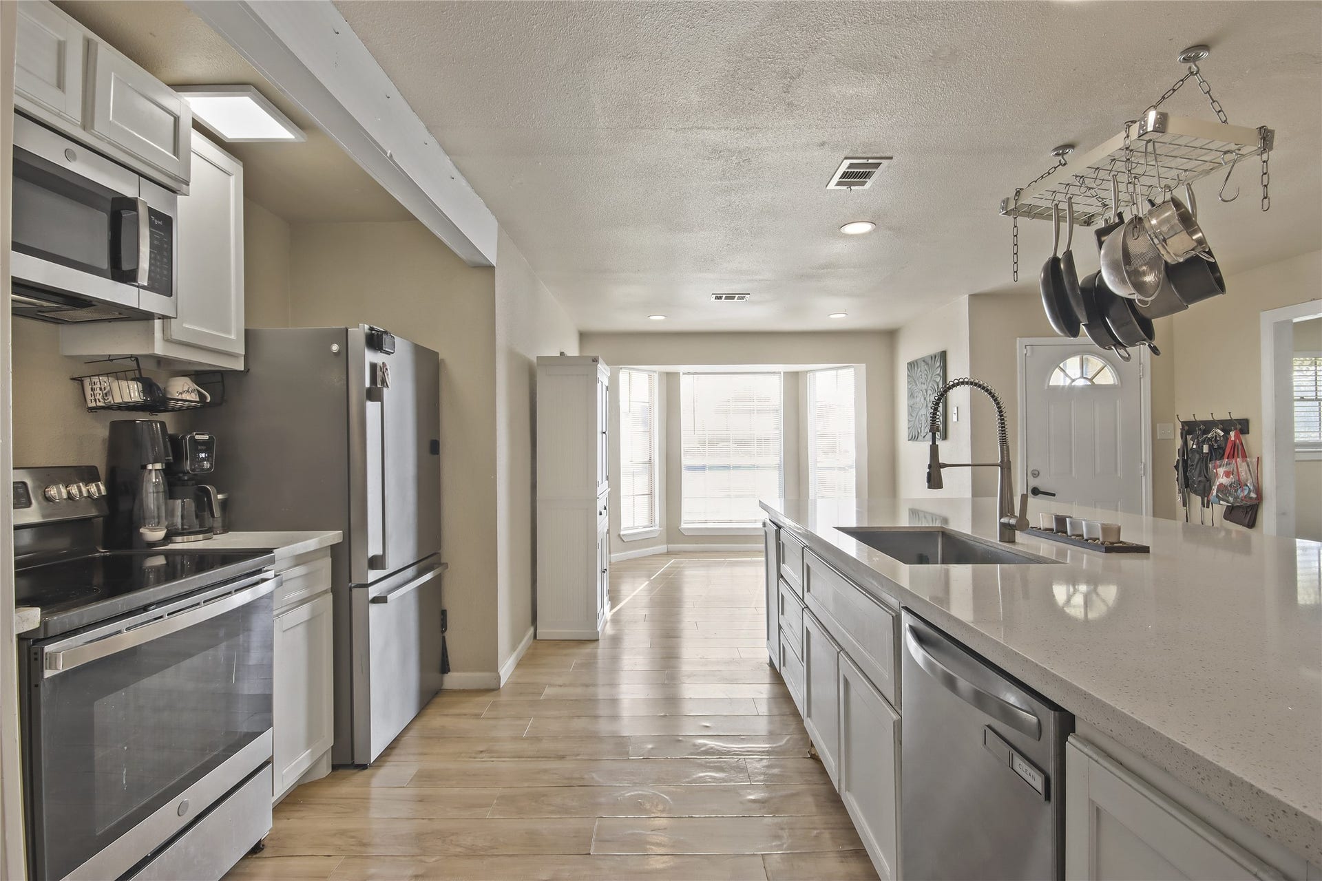 910 Centerwood Drive, Houston, TX 77013 High end appliances and a lot of counter space complete the kitchen, with a pass-through view to the sunlit breakfast nook.