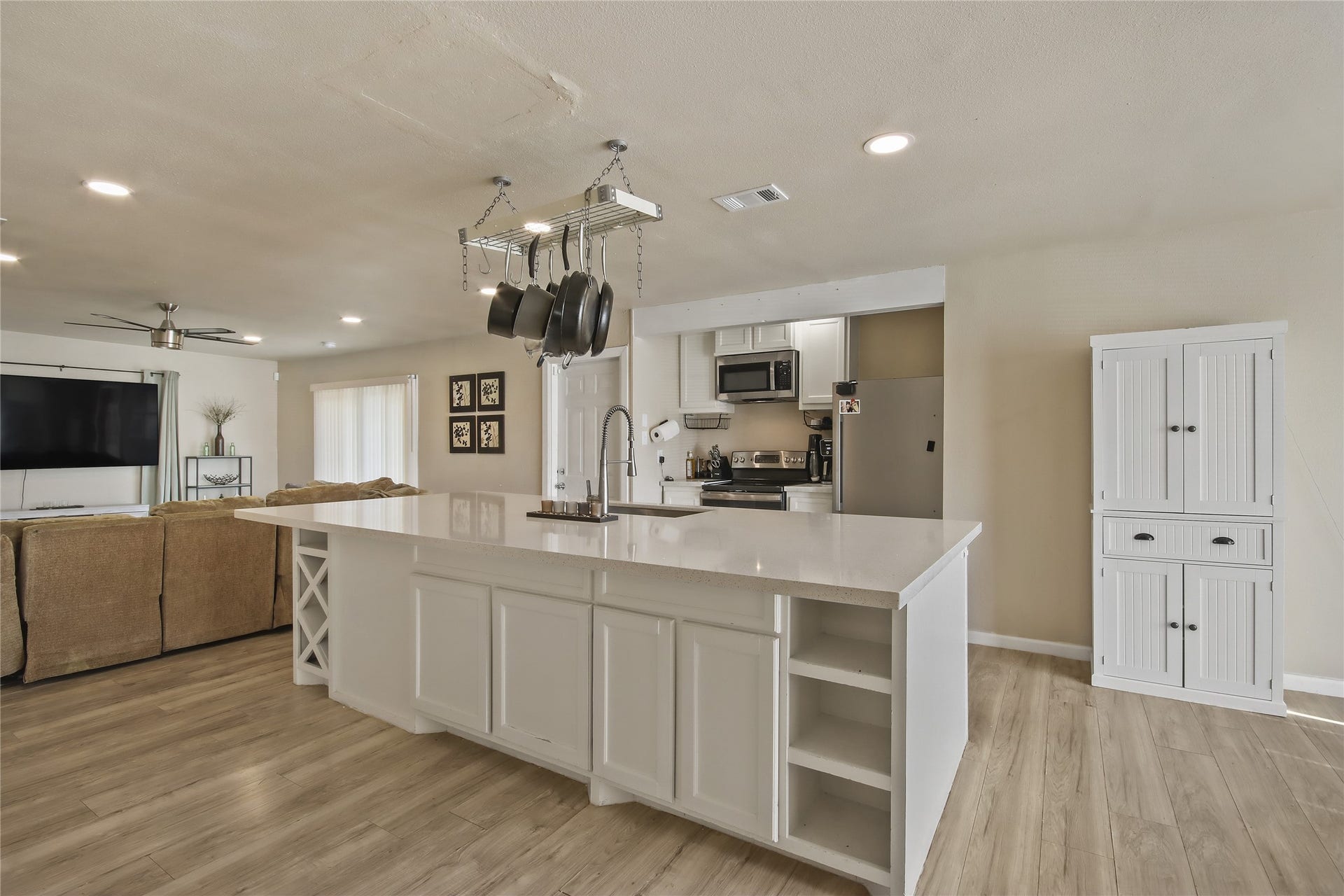 910 Centerwood Drive, Houston, TX 77013 The kitchen island includes a built-in sink, providing extra workspace for meal prep and entertaining.