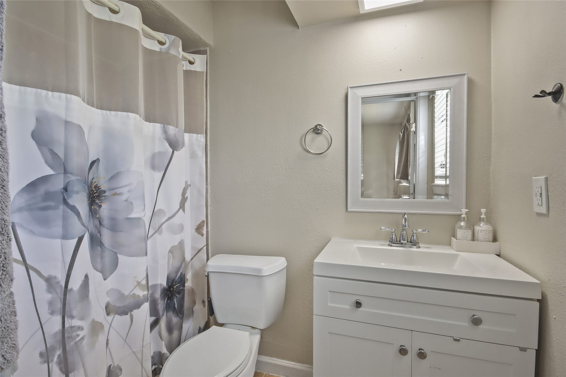 910 Centerwood Drive, Houston, TX 77013 The secondary bathroom includes a tub-and-shower combination and a crisp white vanity with storage, creating a practical space.