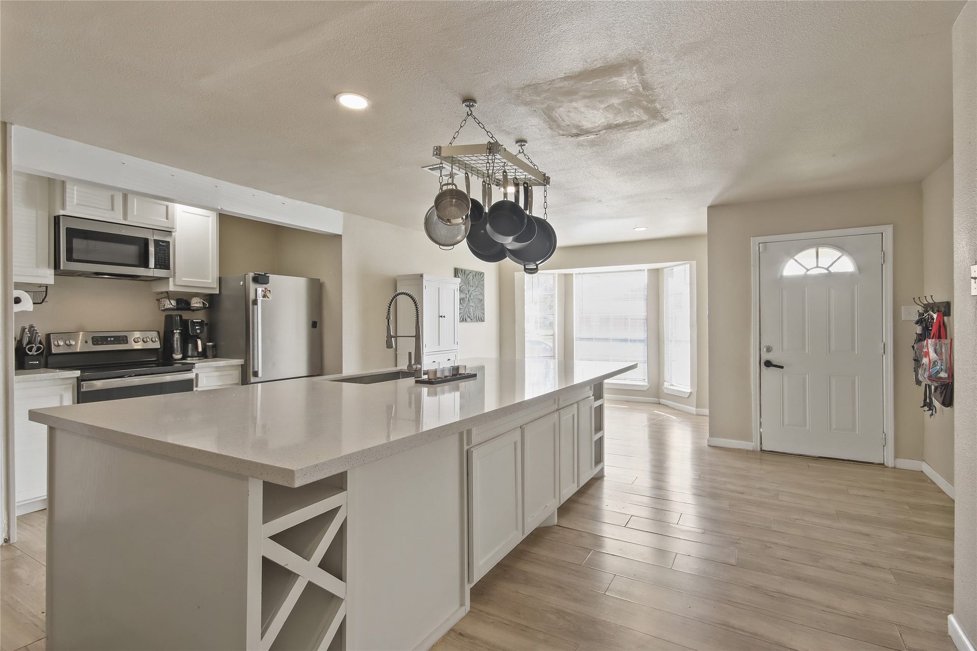 910 Centerwood Drive, Houston, TX 77013 The kitchen offers a spacious island with durable counters and breakfast bar seating, opening directly to the living area.