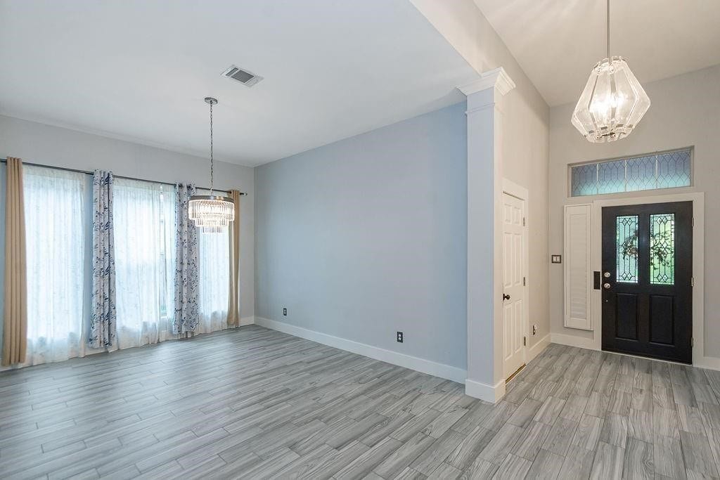 Great shot of formal living room that can be a great work from home space with large windows flooding this room with tons of natural light