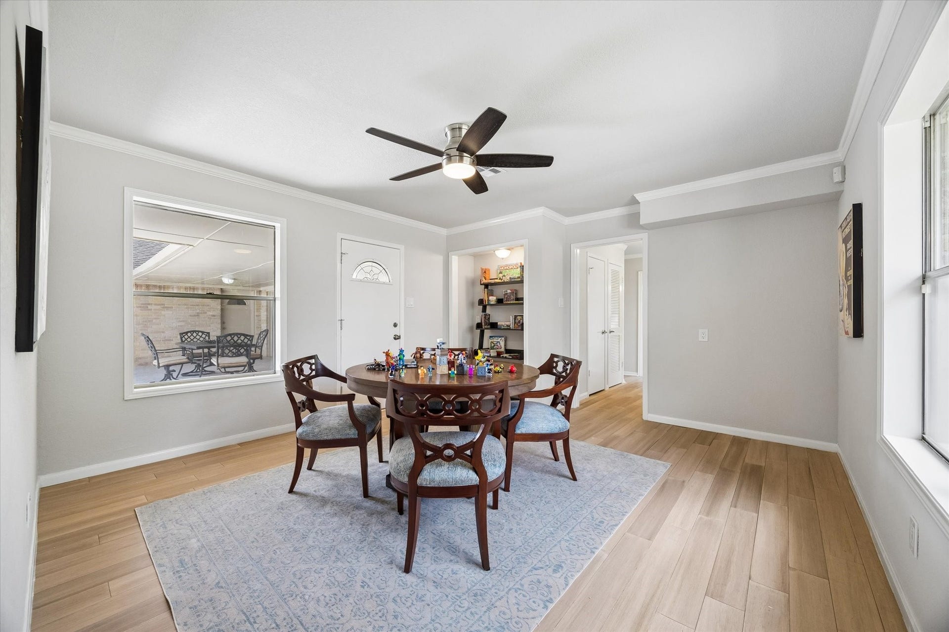 3122 Peach Tree Lane, Missouri City, TX 77459 Bright flex room with light wood floors, neutral walls, and a ceiling fan. Features a large window and glass door leading to outdoor patio. Cozy and inviting space.