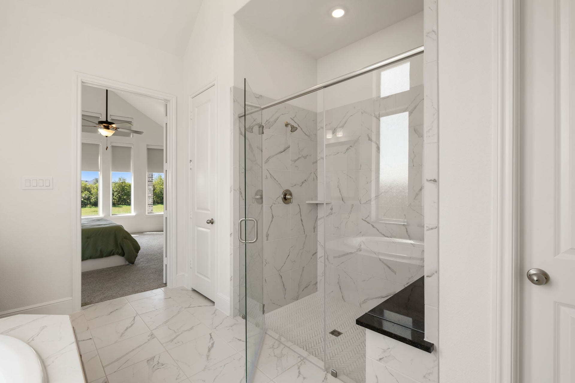 6903 Shoreline View Drive, Katy, TX 77493 Sleek glass-enclosed shower with elegant marble tile!