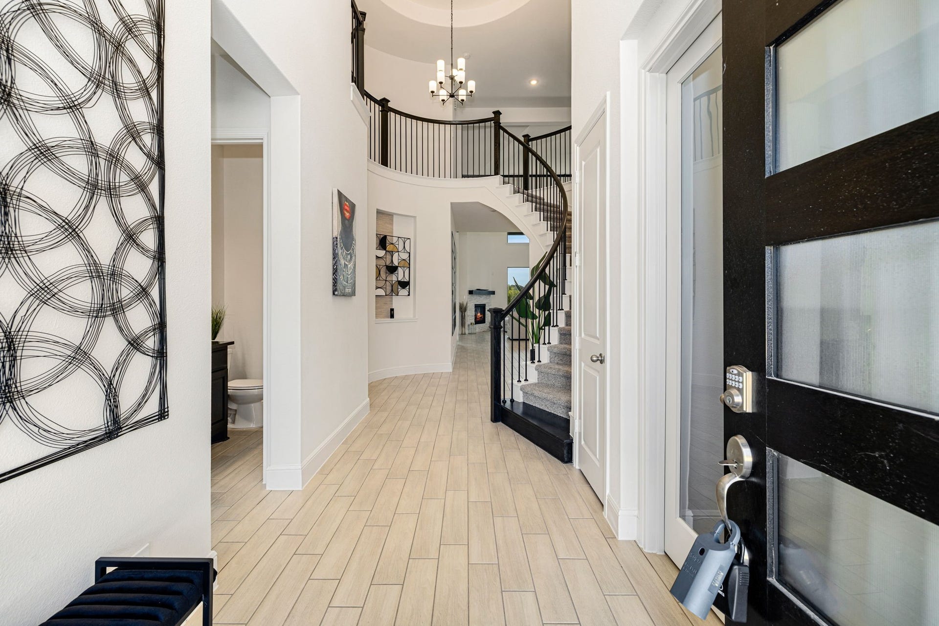 6903 Shoreline View Drive, Katy, TX 77493 High ceilings, a grand curved staircase, and contemporary decor, offering a welcoming ambiance!
