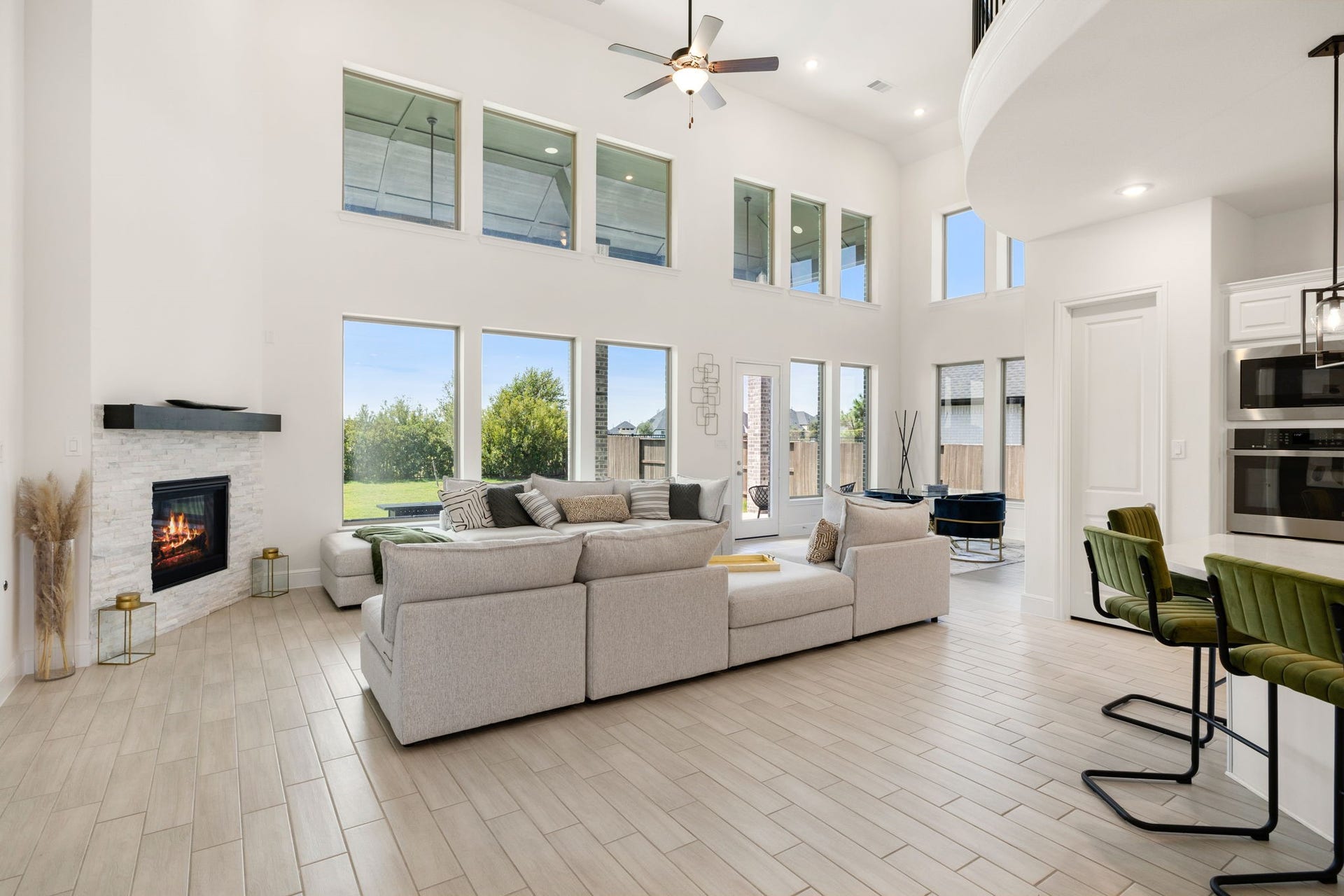 6903 Shoreline View Drive, Katy, TX 77493 Stunning open-concept living area with soaring ceilings, abundant natural light, and a cozy corner fireplace!