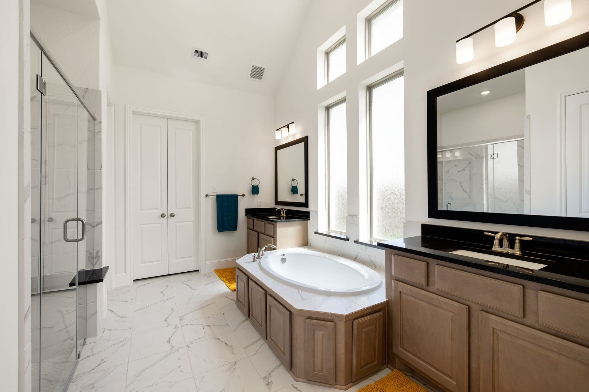 6903 Shoreline View Drive, Katy, TX 77493 Luxurious bathroom featuring a spacious soaking tub, elegant dual vanities with granite countertops!