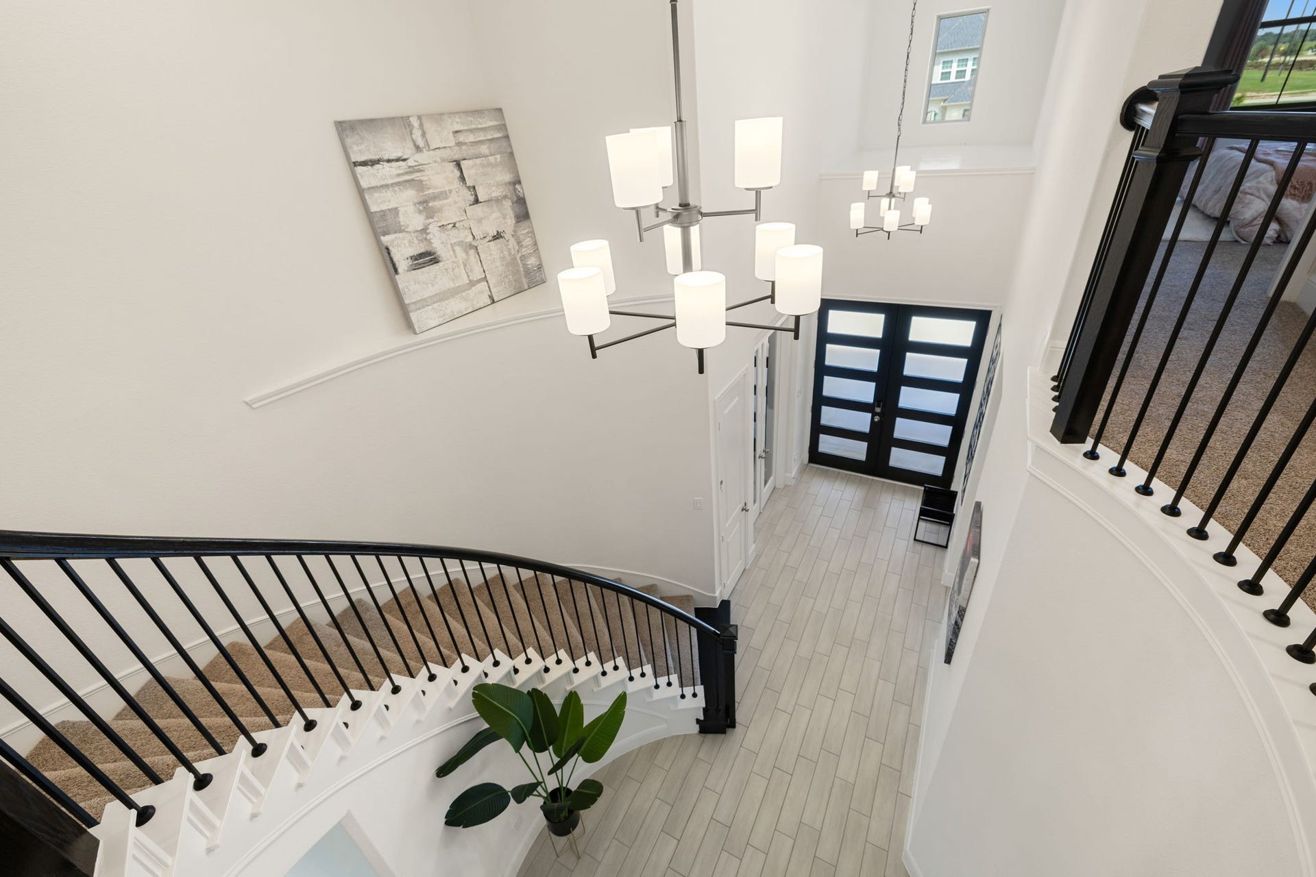 6903 Shoreline View Drive, Katy, TX 77493 Sweeping staircase, modern chandelier, and sleek double-door entry, creating a stunning first impression!