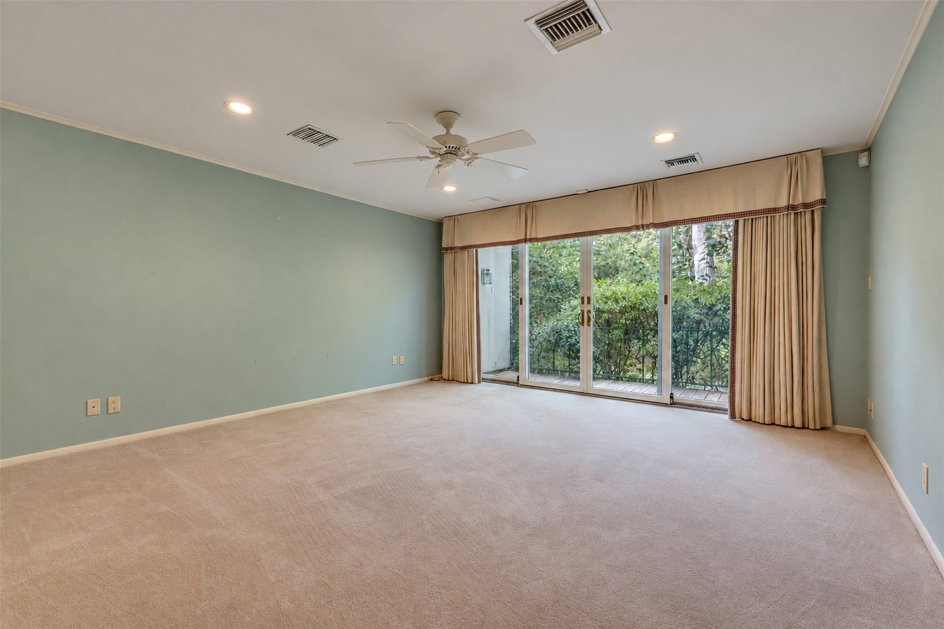 The master bedroom has a private patio and looks out over the back yard.