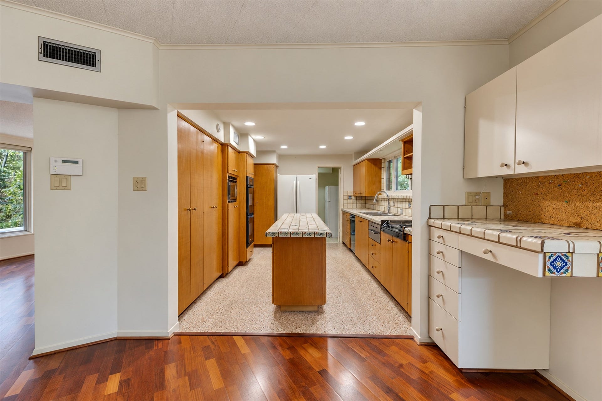 The kitchen has a small desk by the back door.