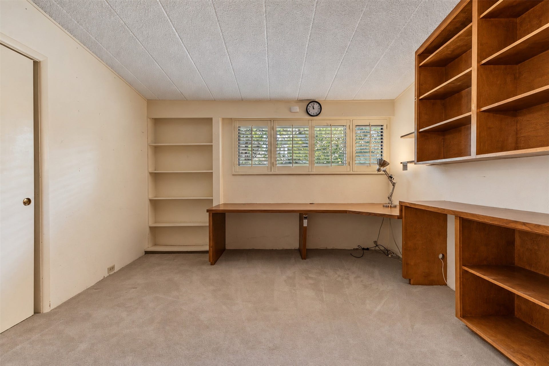 The study has built-in shelving and desk.