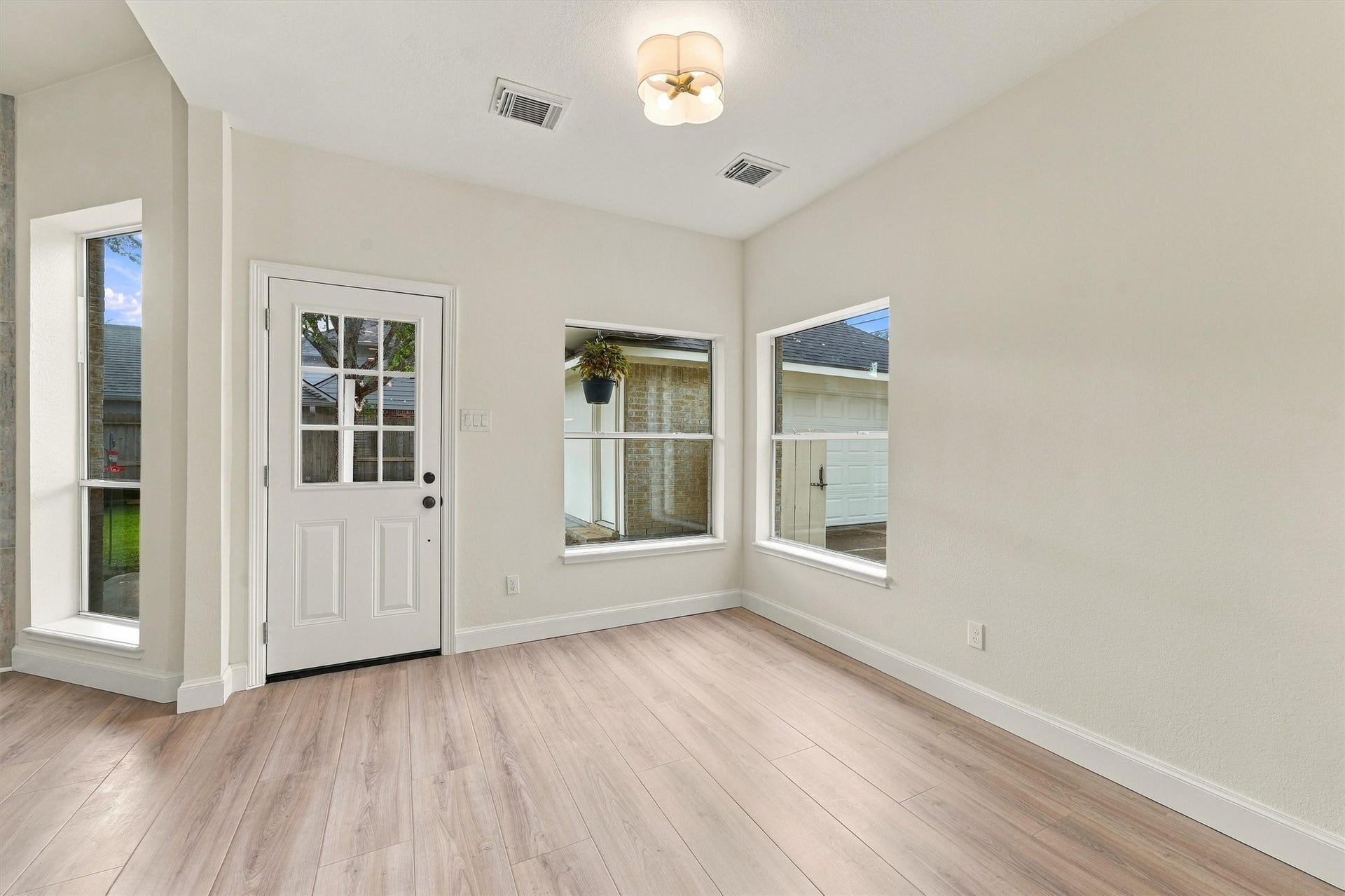 22415 Elizabeth Place Court, Katy, TX 77494 Breakfast area with wood flooring, glass-paneled door, and multiple windows for abundant natural light.