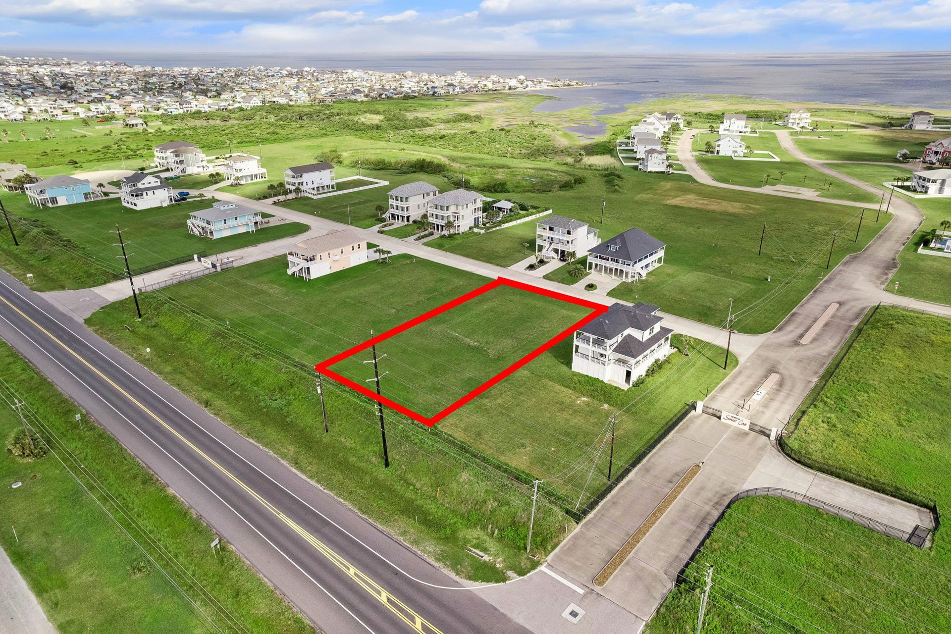 21205 Scissor Tail Lane, Galveston, TX 77554 Gated entry into Sunset Cove leads to paved community streets that run right to the property line, creating a clean approach for a future driveway and build site.