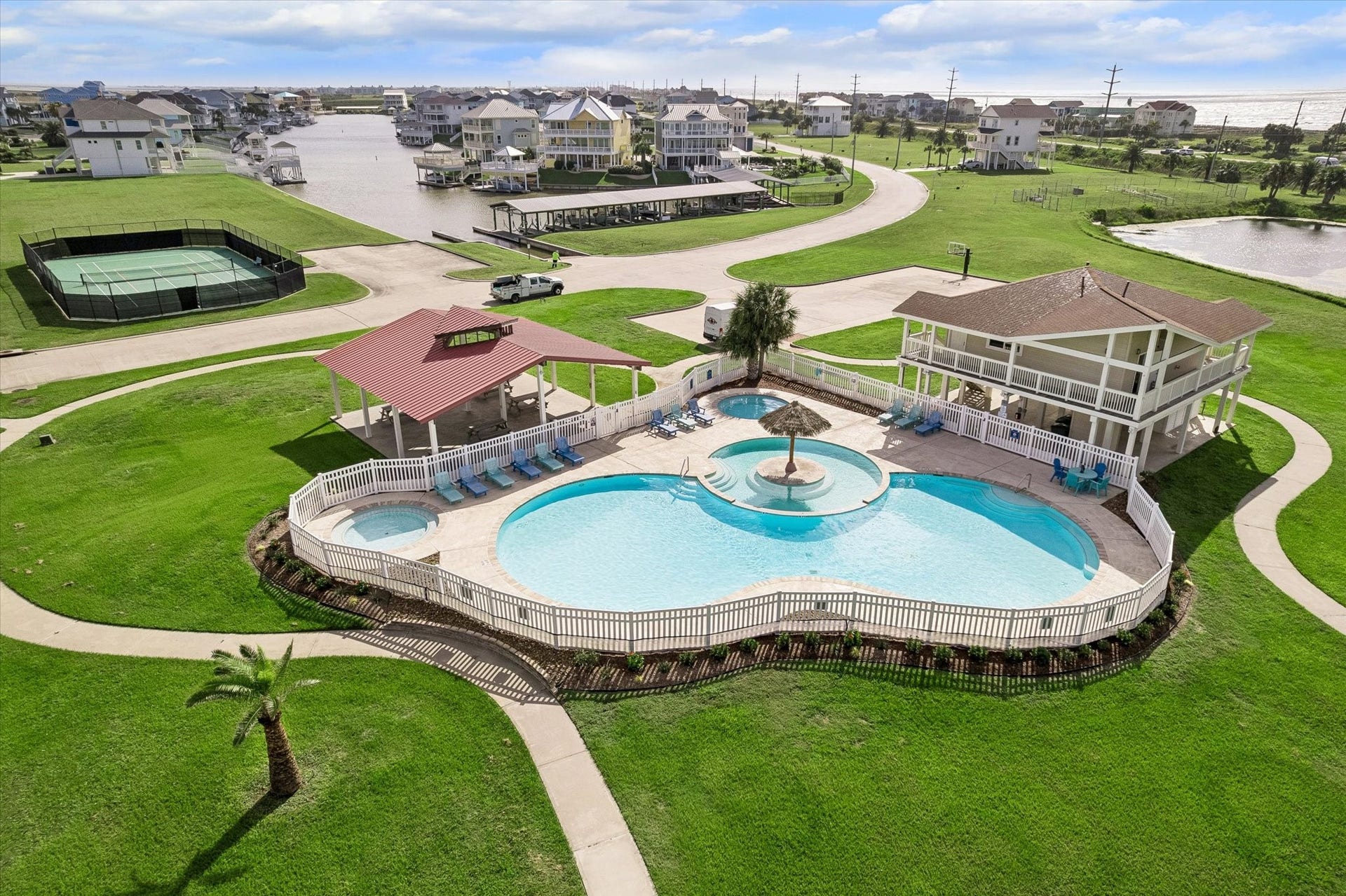 21205 Scissor Tail Lane, Galveston, TX 77554 Residents gather at the community pool and clubhouse, where well kept lawns wrap a resort-style retreat.