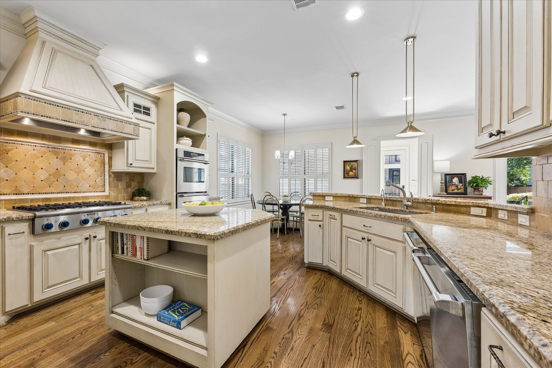 4037 Dumbarton Street, Houston, TX 77025 The spacious kitchen, with ample countertop space, a central island, and stainless steel appliances, is complemented by abundant cabinetry and hardwood floors.