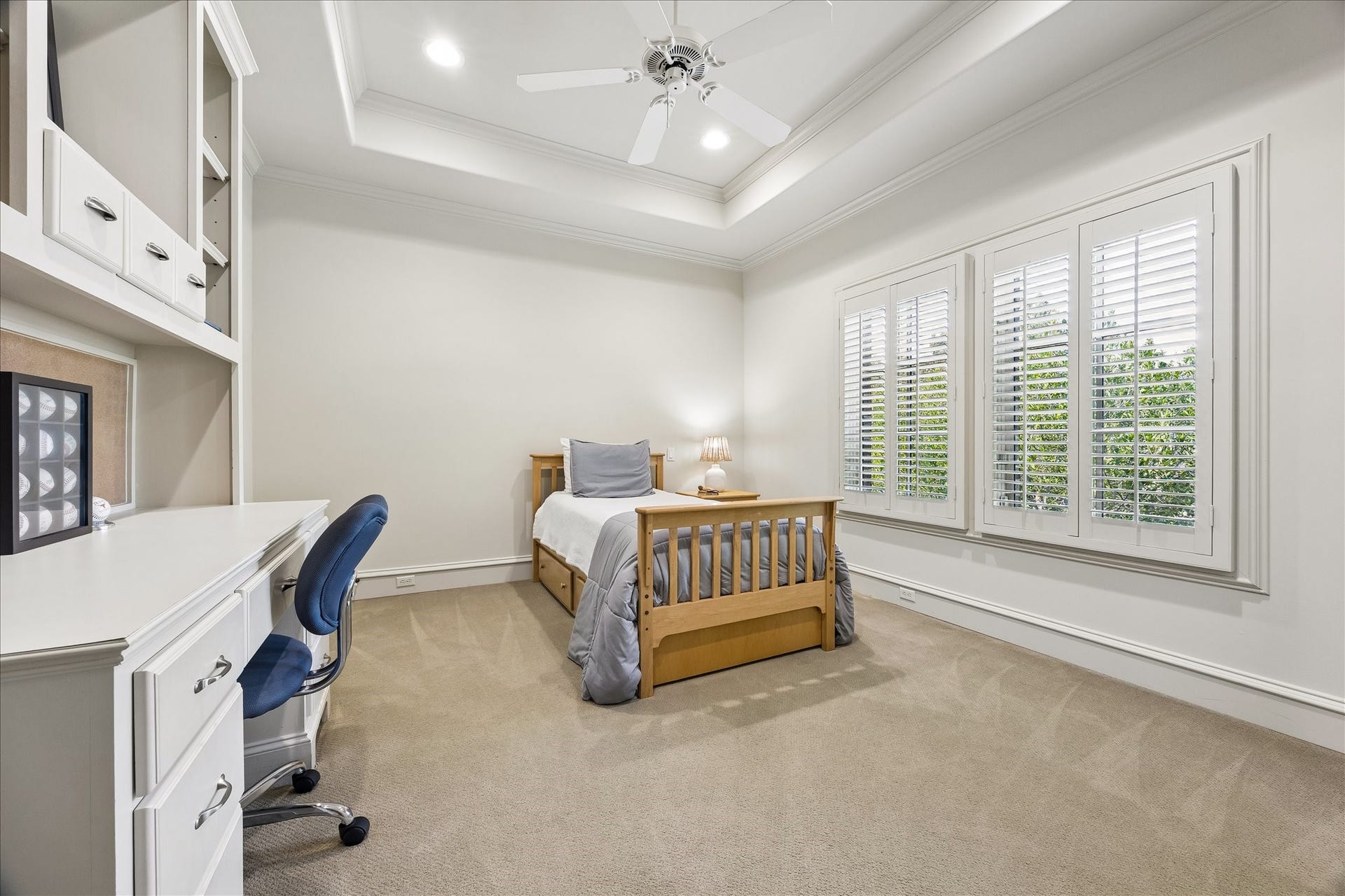 4037 Dumbarton Street, Houston, TX 77025 Bright and inviting secondary bedroom #1 features large windows with plantation shutters, offering ample natural light. Built-in desk area and large walk-in closet complete this space.