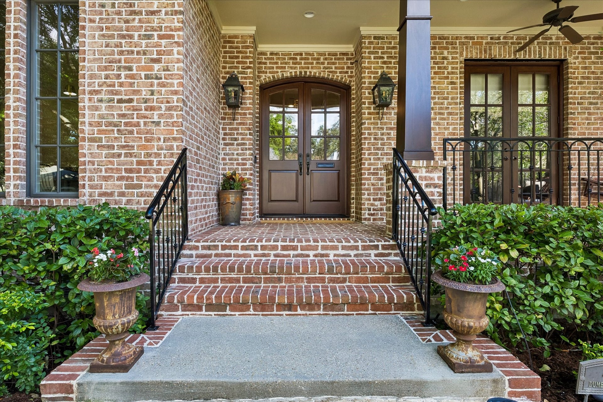 4037 Dumbarton Street, Houston, TX 77025 Charming brick entrance with elegant double doors, classic lantern-style lighting, and manicured greenery, offering a warm welcome.
