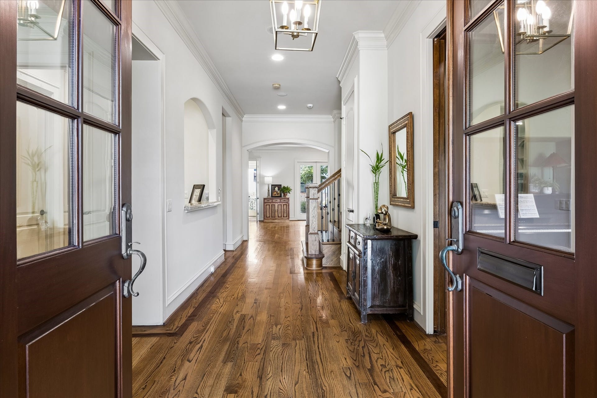 4037 Dumbarton Street, Houston, TX 77025 Step into the expansive entryway featuring rich hardwood floors, sophisticated lighting, and a welcoming atmosphere that leads into the heart of the home.