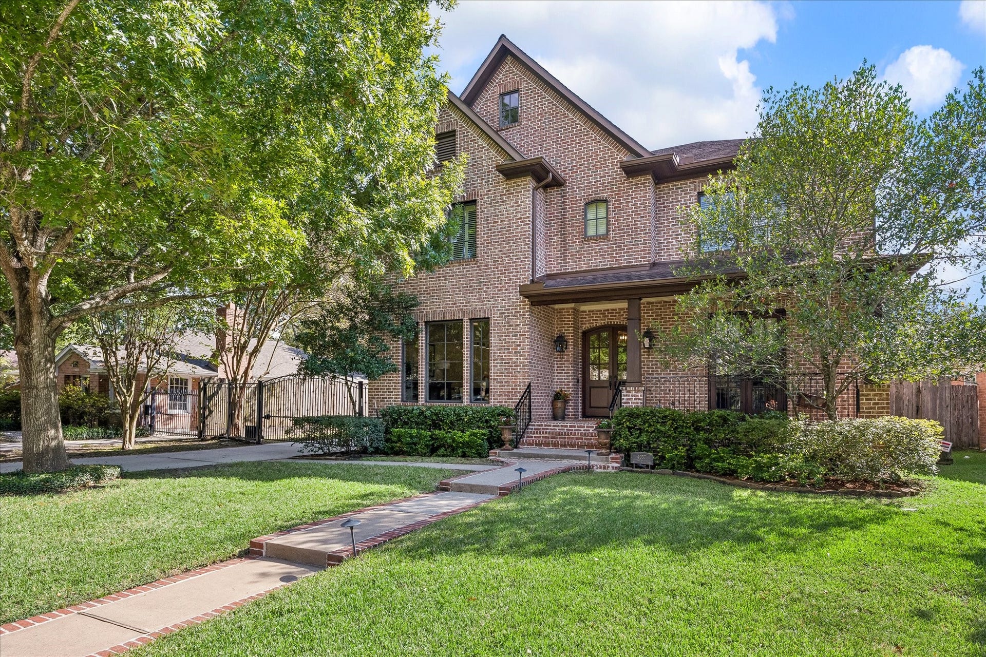 4037 Dumbarton Street, Houston, TX 77025 A Custom classic brick home with a welcoming front porch, nestled among mature trees and lush greenery, offers a serene, inviting atmosphere in sought-after Aryshire!