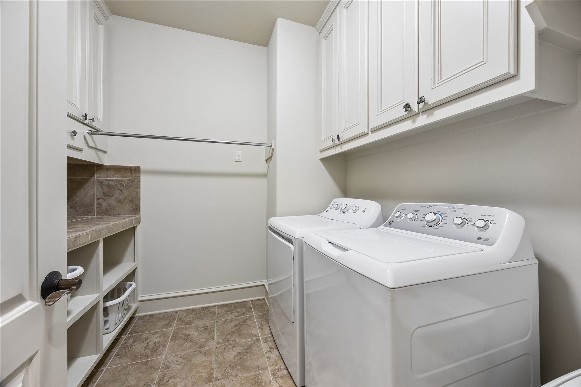 4037 Dumbarton Street, Houston, TX 77025 The spacious laundry room features tons of cabinetry and a convenient folding counter for efficient organization.