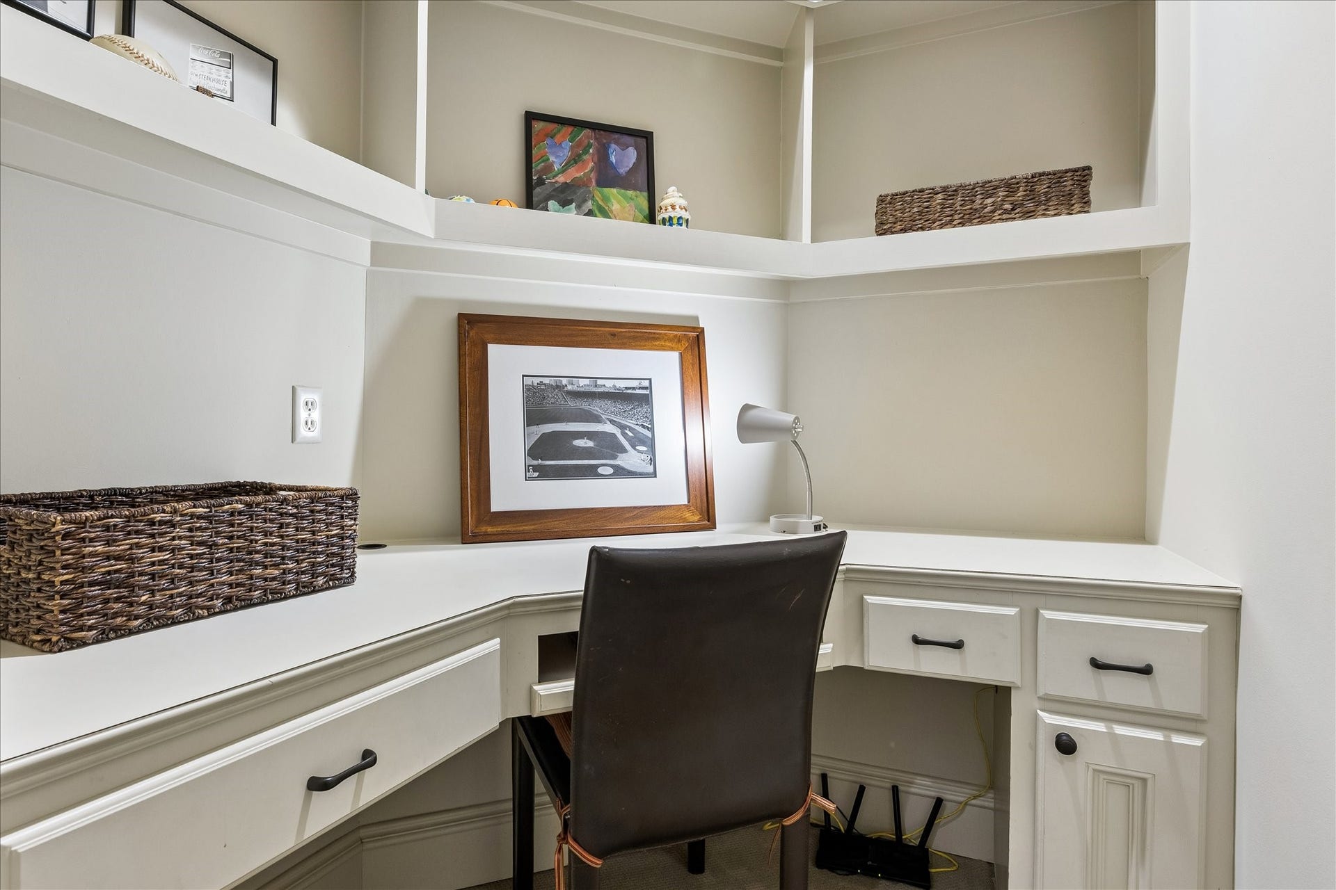 4037 Dumbarton Street, Houston, TX 77025 Charming home office nook with built-in desk, ample shelving, and a cozy workspace atmosphere opens to the wonderful game room!