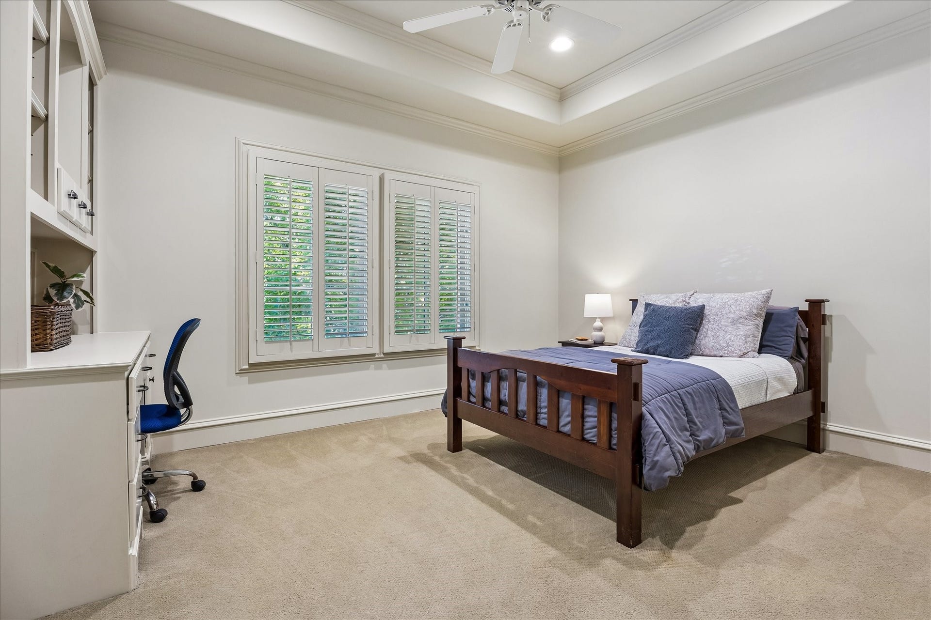 4037 Dumbarton Street, Houston, TX 77025 Bright and inviting secondary bedroom #2 features large windows with plantation shutters, offering ample natural light. Built-in desk area and large walk-in closet complete this space.