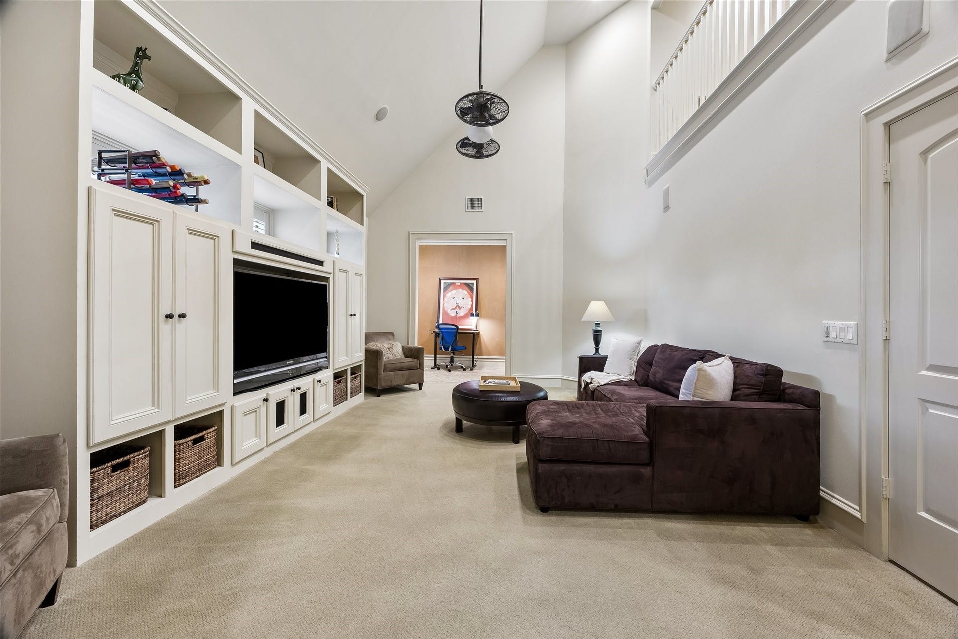 4037 Dumbarton Street, Houston, TX 77025 Spacious game room with vaulted ceilings, features a built-in entertainment center and explanisve seating, complemented by an adjacent office nook on one side, an art room/flex room on the other side, and a loft above, all for added functionality. This room has it ALL!