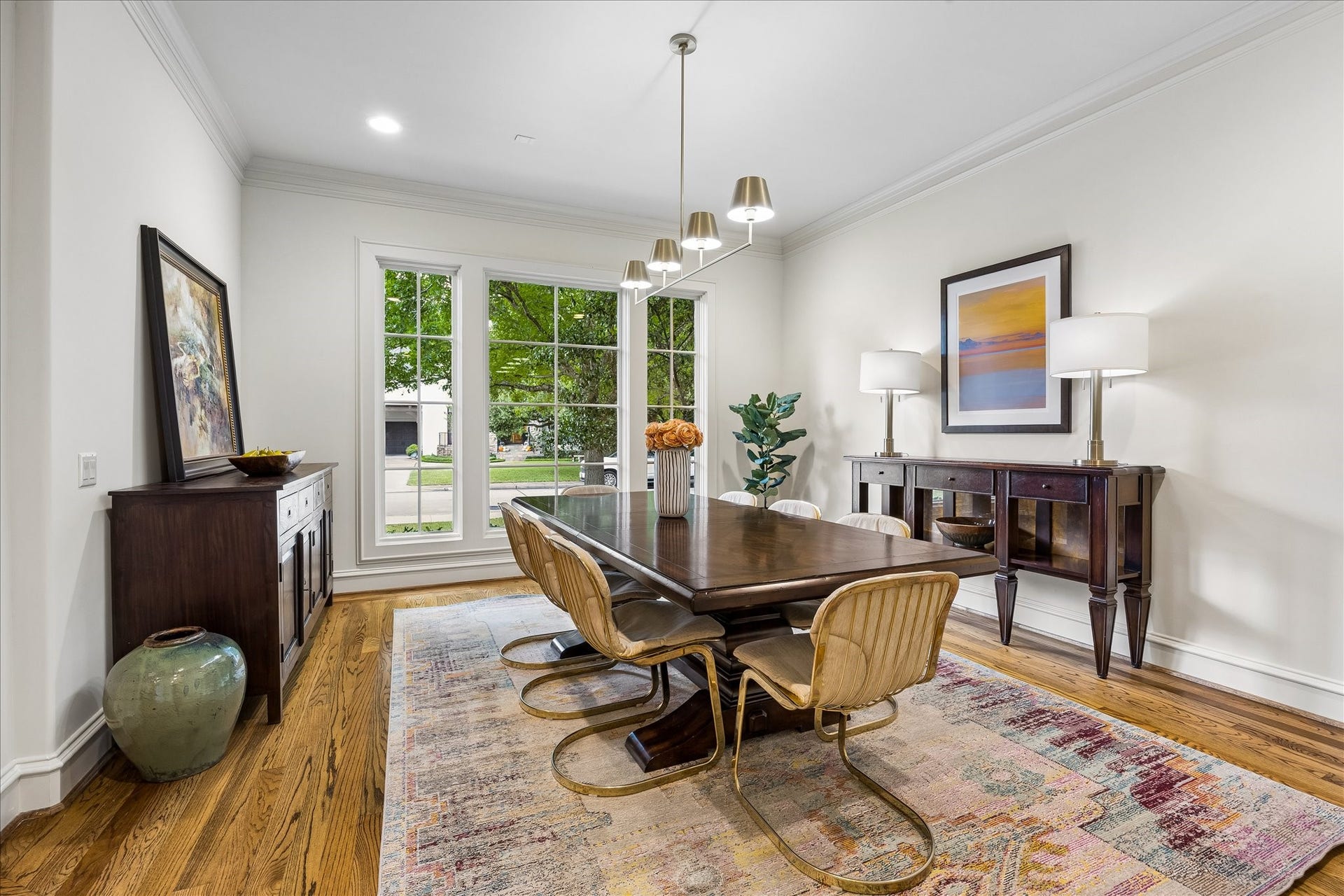 4037 Dumbarton Street, Houston, TX 77025 Bright and inviting formal dining room featuring large windows bringing in an abundance of natural light and a new stylish chandelier all set on beautiful hardwood floors is waiting for entertaining!