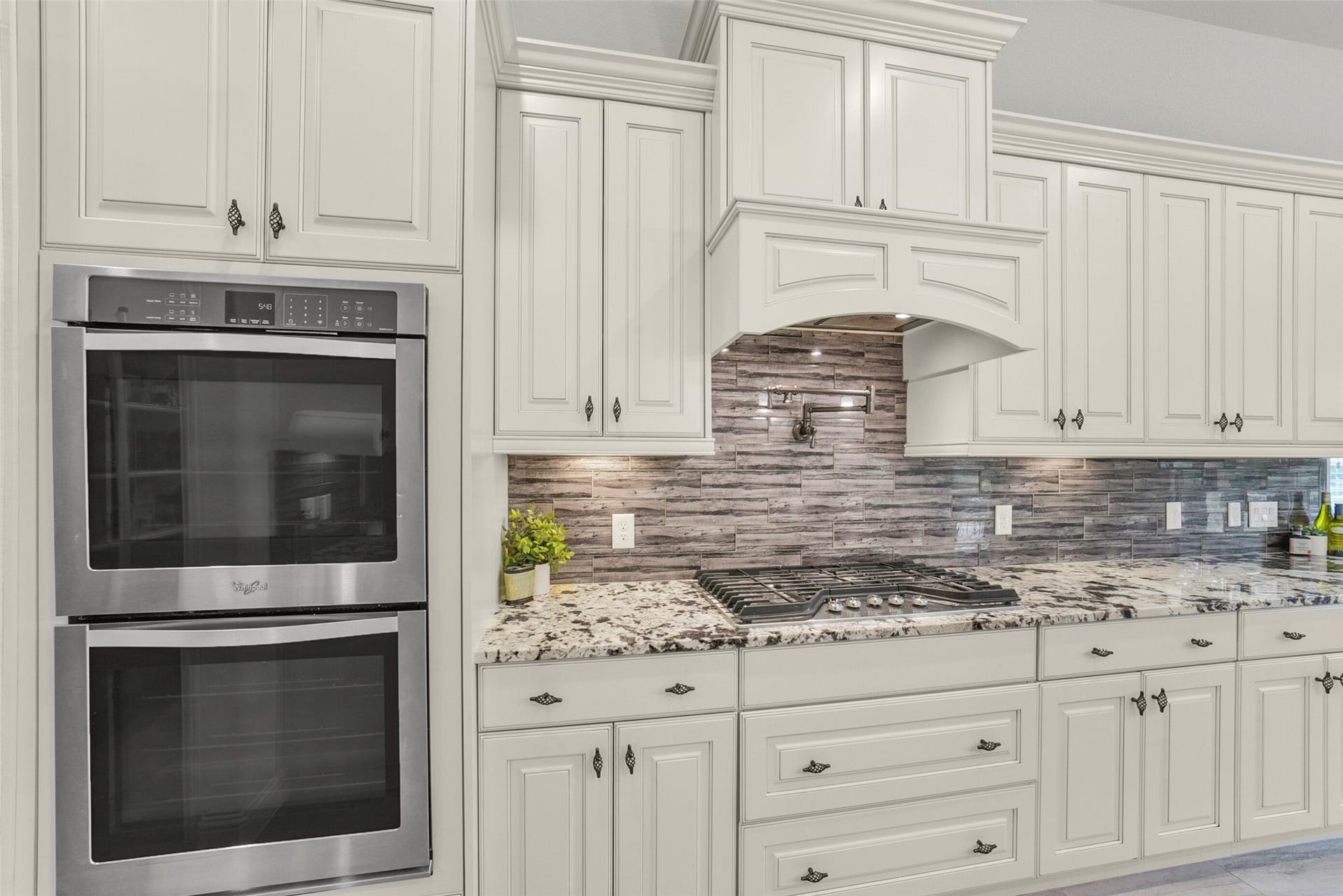 21011 Atascocita Point Drive, Humble, TX 77346 Stainless double oven, gas stove and pot filler.