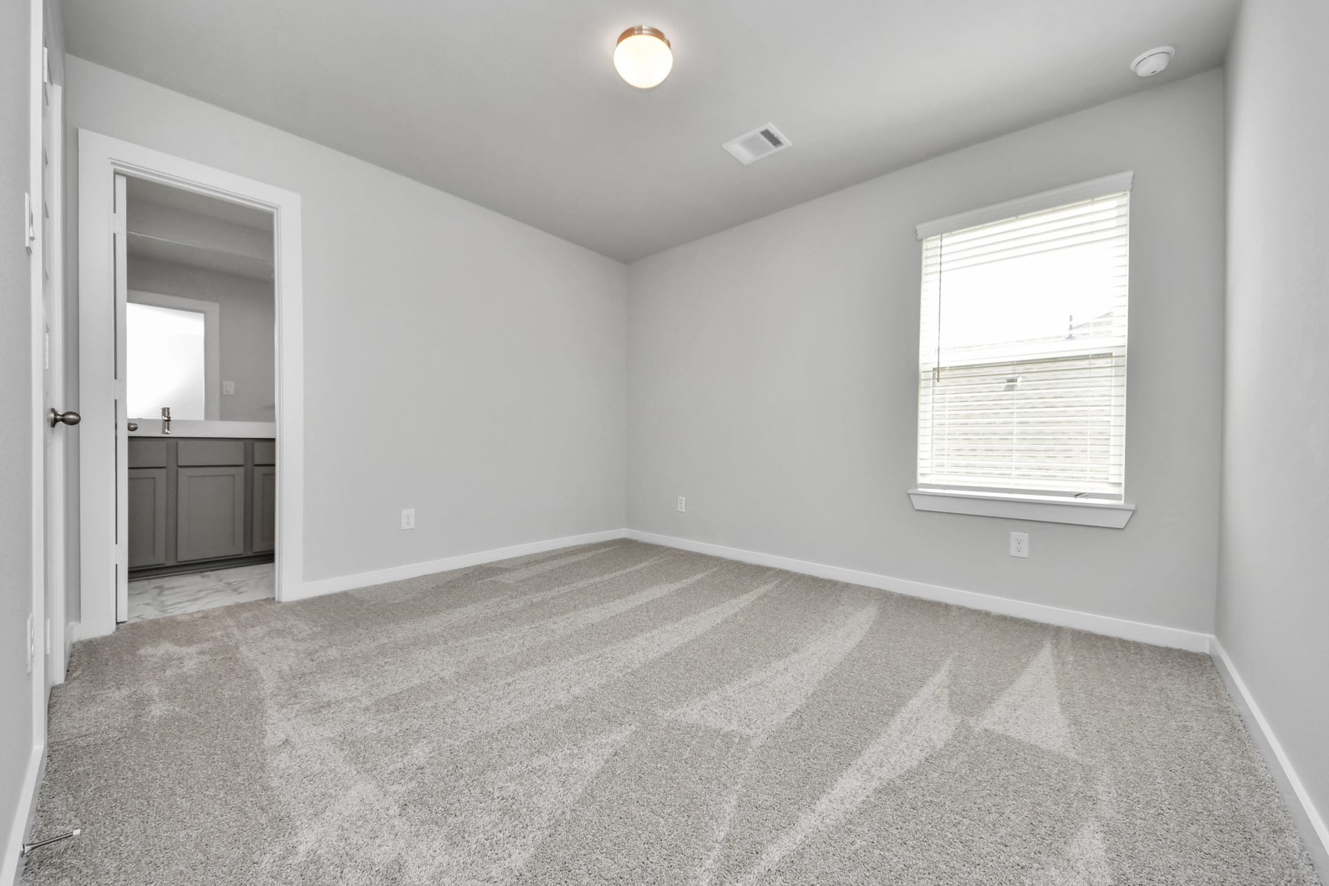 15315 Geranium Field Drive, Houston, TX 77044 Secondary bedroom features plush carpeting, large windows that let in plenty of natural light, bright paint, and spacious closets. Sample photo of completed home with similar floor plan. Actual colors and selections may vary.
