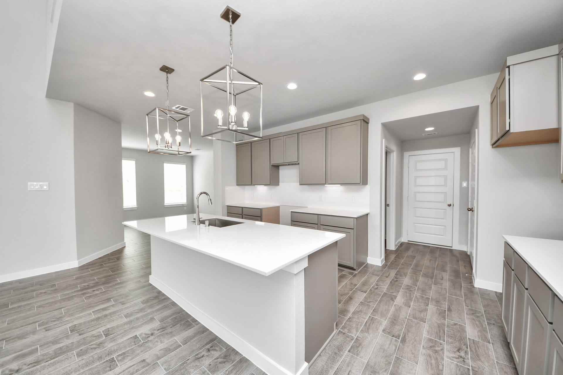 15315 Geranium Field Drive, Houston, TX 77044 The extended counter area adds both practicality and style, making meal preparation a breeze. Every detail is thoughtfully designed to enhance the kitchen's functionality and aesthetic appeal. Sample photo of completed home with similar floor plan. Actual colors and selections may vary.