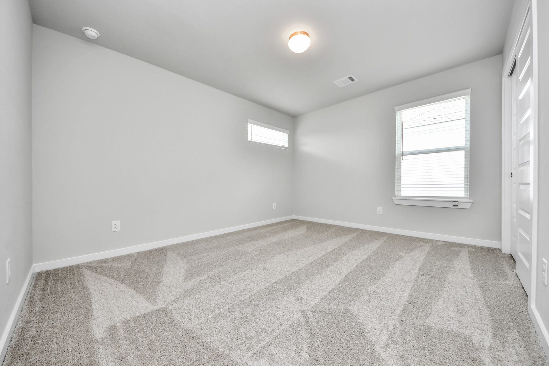15315 Geranium Field Drive, Houston, TX 77044 Generously sized secondary bedrooms featuring spacious closets, soft and inviting carpeting underfoot, large windows allowing plenty of natural light, and the added touch of privacy blinds for your personal retreat. Sample photo of completed home with similar floor plan. Actual colors and selections may vary.