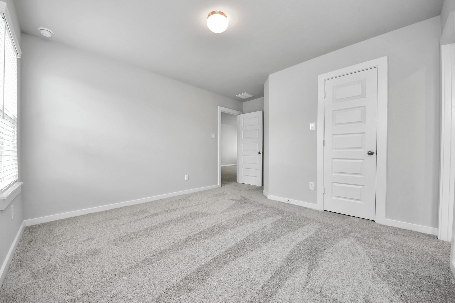 15315 Geranium Field Drive, Houston, TX 77044 Generously sized secondary bedrooms featuring spacious closets, soft and inviting carpeting underfoot, large windows allowing plenty of natural light, and the added touch of privacy blinds for your personal retreat. Sample photo of completed home with similar floor plan. Actual colors and selections may vary.