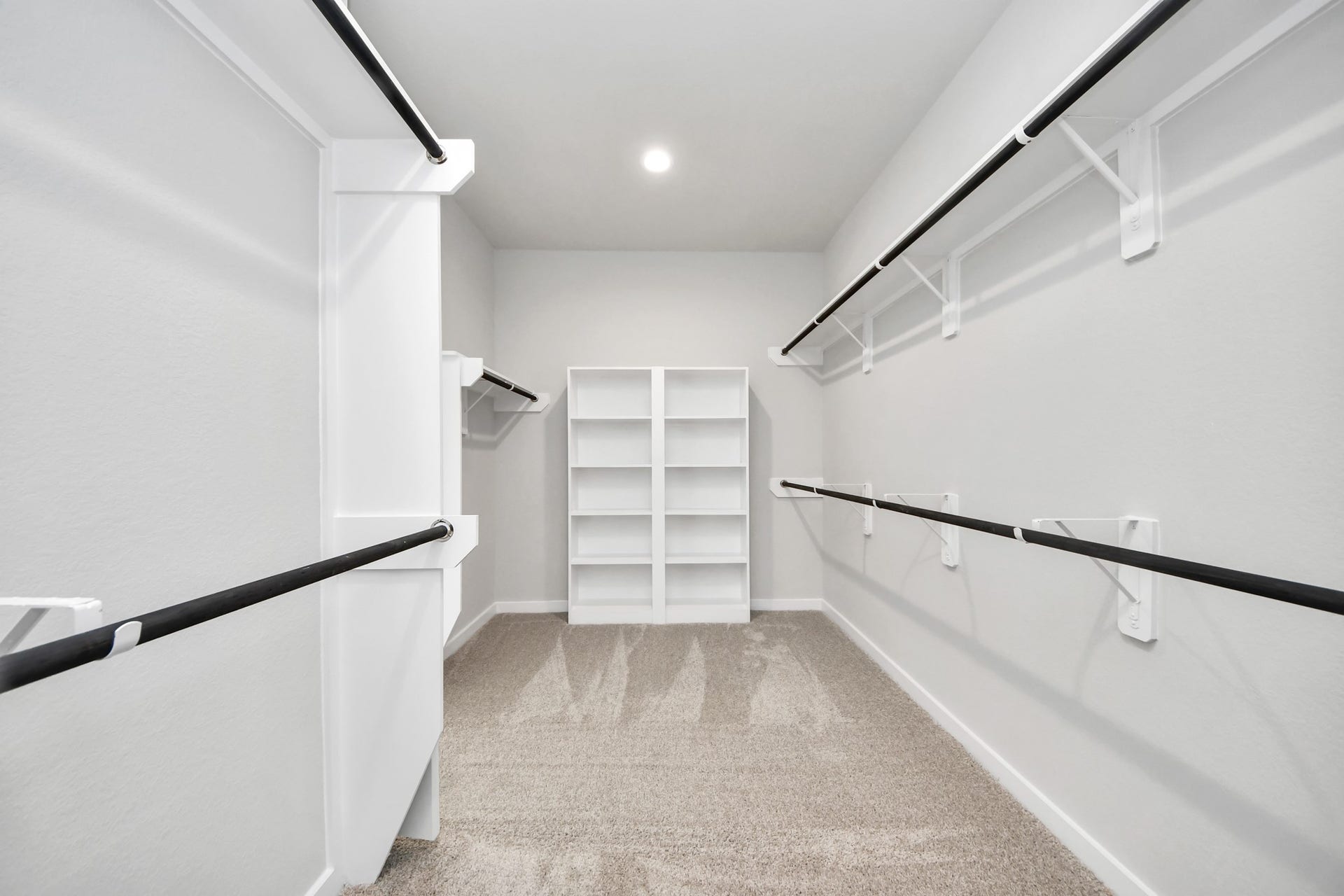 15315 Geranium Field Drive, Houston, TX 77044 Walk-in closet that epitomizes luxury and practicality. This generously sized space features built-in shelving, offering abundant room for impeccable organization. High ceilings and recessed lighting create a bright and welcoming ambiance. Sample photo of completed home with similar floor plan. Actual colors and selections may vary.
