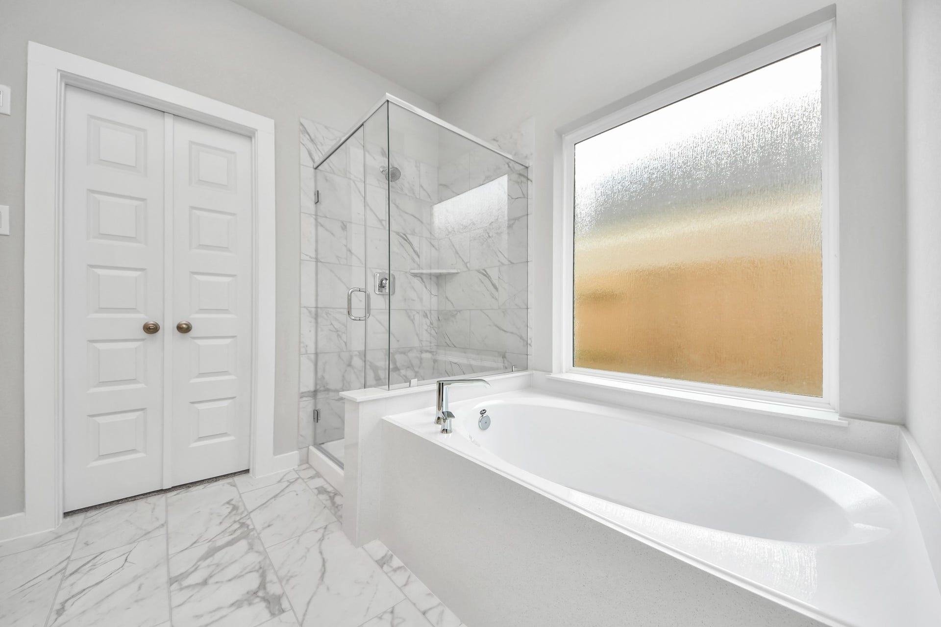 15315 Geranium Field Drive, Houston, TX 77044 Indulge in a spa-like retreat within the confines of this primary bathroom. Delight in a spacious walk-in shower enveloped in stylish tile surround, unwind in a separate garden tub adorned with custom detailing. Sample photo of completed home with similar floor plan. Actual colors and selections may vary.