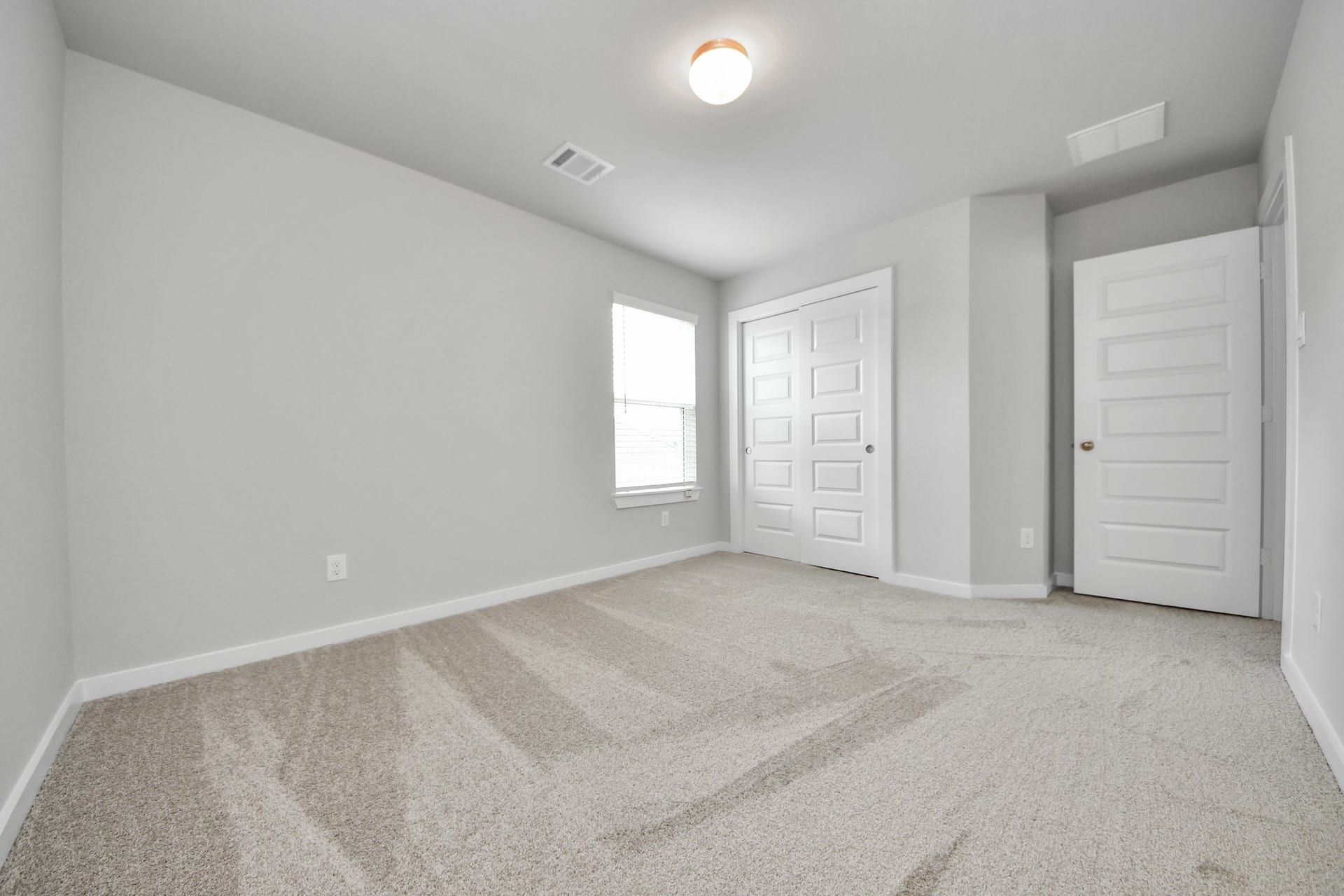 15315 Geranium Field Drive, Houston, TX 77044 Generously sized secondary bedrooms featuring spacious closets, soft and inviting carpeting underfoot, large windows allowing plenty of natural light, and the added touch of privacy blinds for your personal retreat. Sample photo of completed home with similar floor plan. Actual colors and selections may vary.