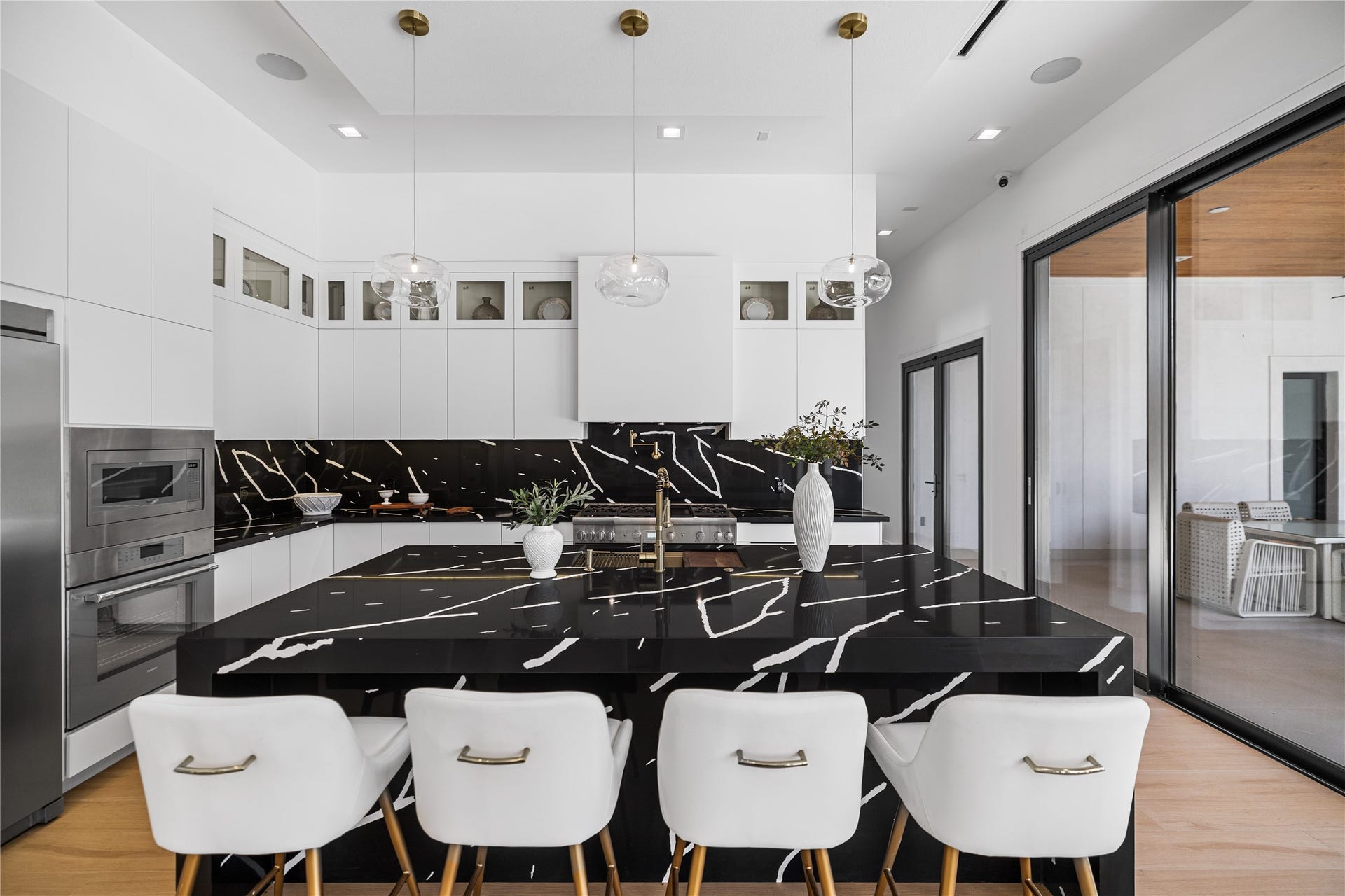 Welcome into your grand island kitchen. This custom kitchen slab reflects a previous buyer's selection; the builder welcomes discussing cosmetic updates to suit your vision.