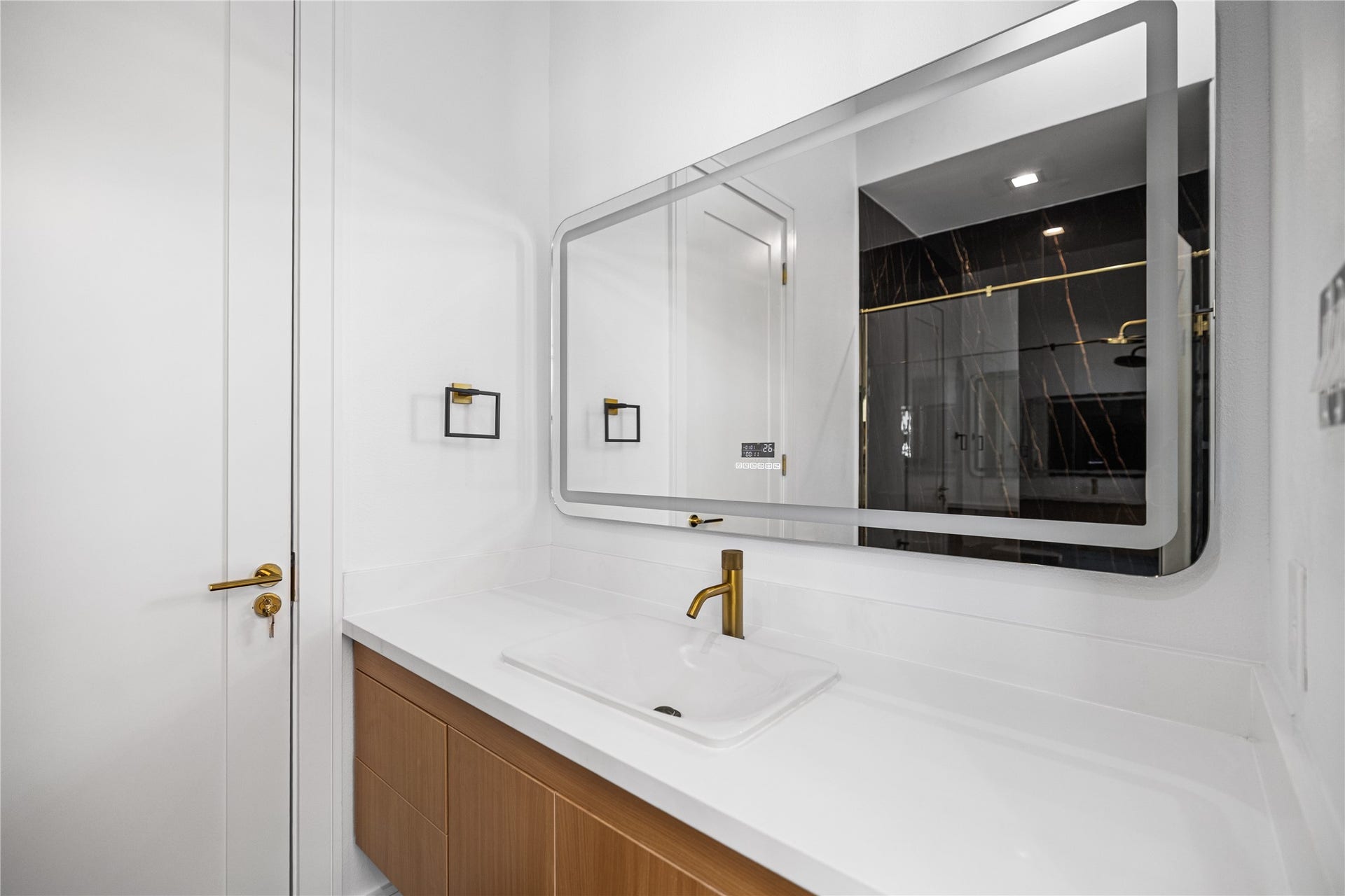 The first-floor guest suite's private en-suite bath features a spacious walk-in shower, walk-in closet and elevated finishes.