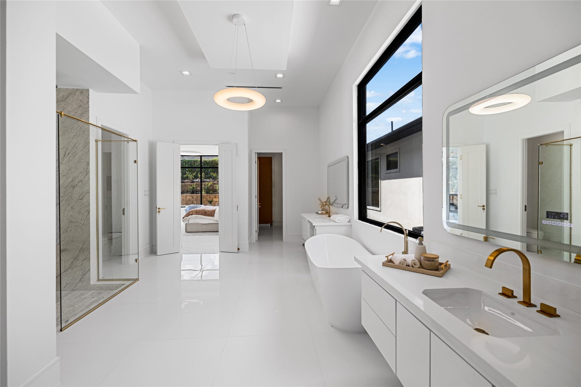 A reverse view of this luxurious primary bath showcasing the second custom walk-in closet and its seamless connection to the serene primary suite. Just to the left of this picture is a dedicated make-up vanity.