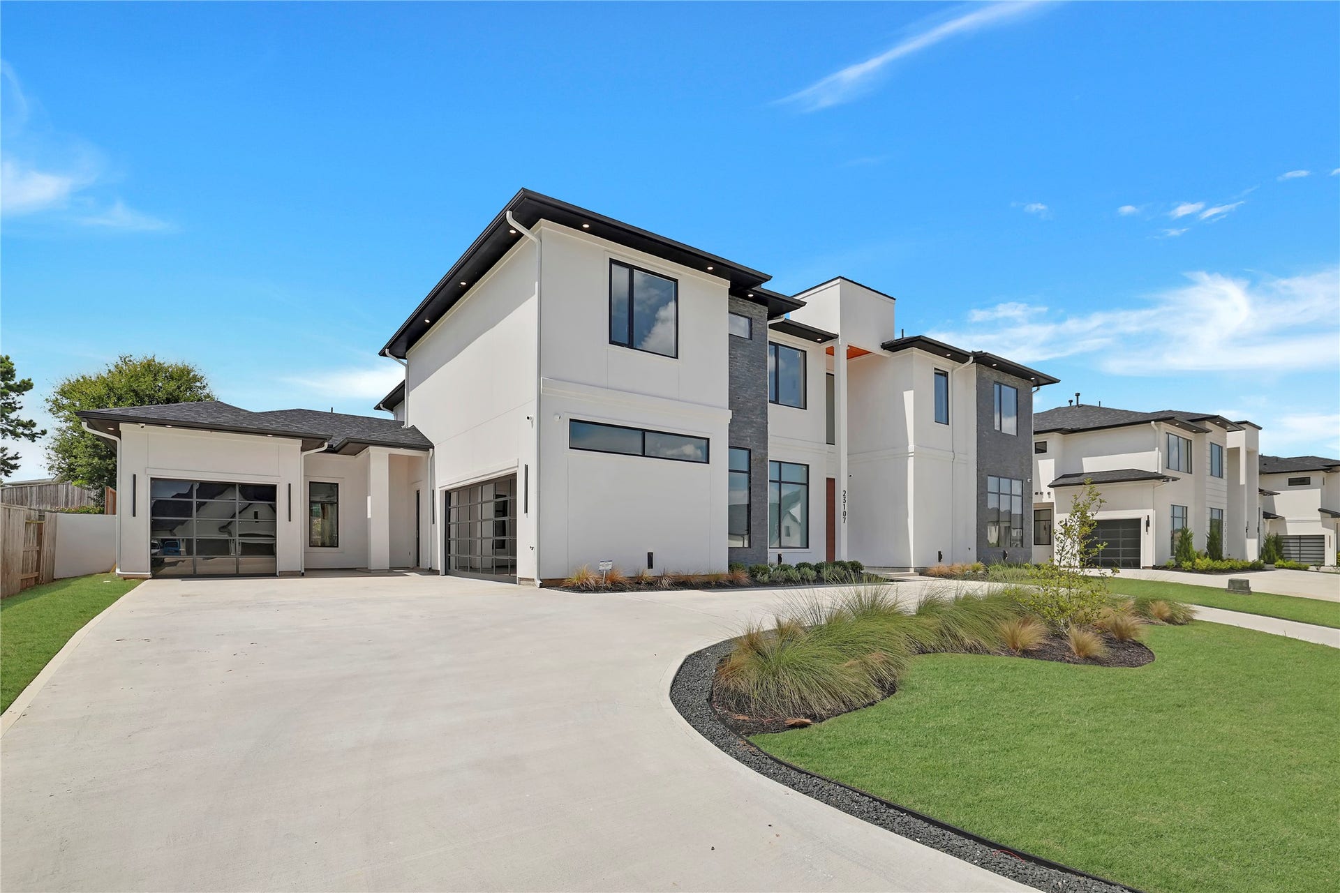 A sweeping circular driveway welcomes you to this residence, while a separate extended driveway provides convenient access to two separate garages that hold three cars. The generous driveways offer abundant parking and an impressive estate-style arrival.