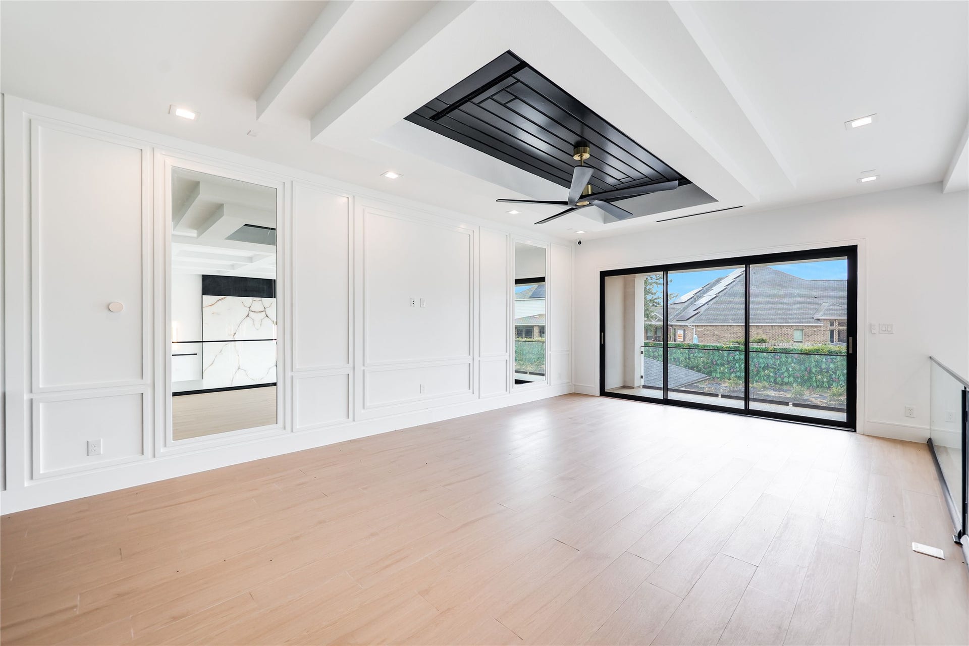 Custom millwork defines the game room wall, thoughtfully designed with integrated media connections for a seamless television and entertainment setup.