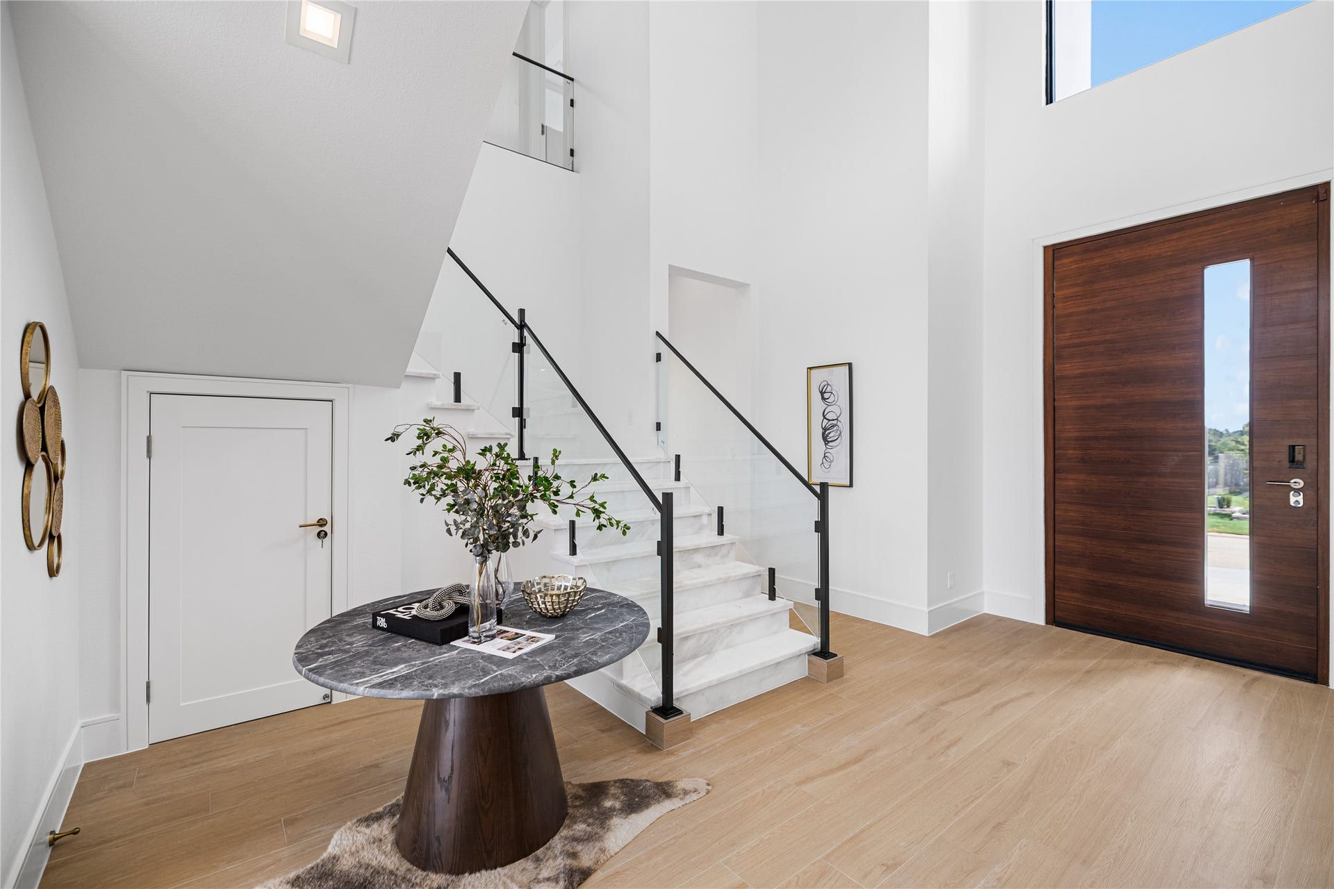 A reverse view of your two-story foyer. Imagine your own console table here, topped with fresh flowers and framed art. It is the perfect first hello for every guest who walks through your oversized front door.