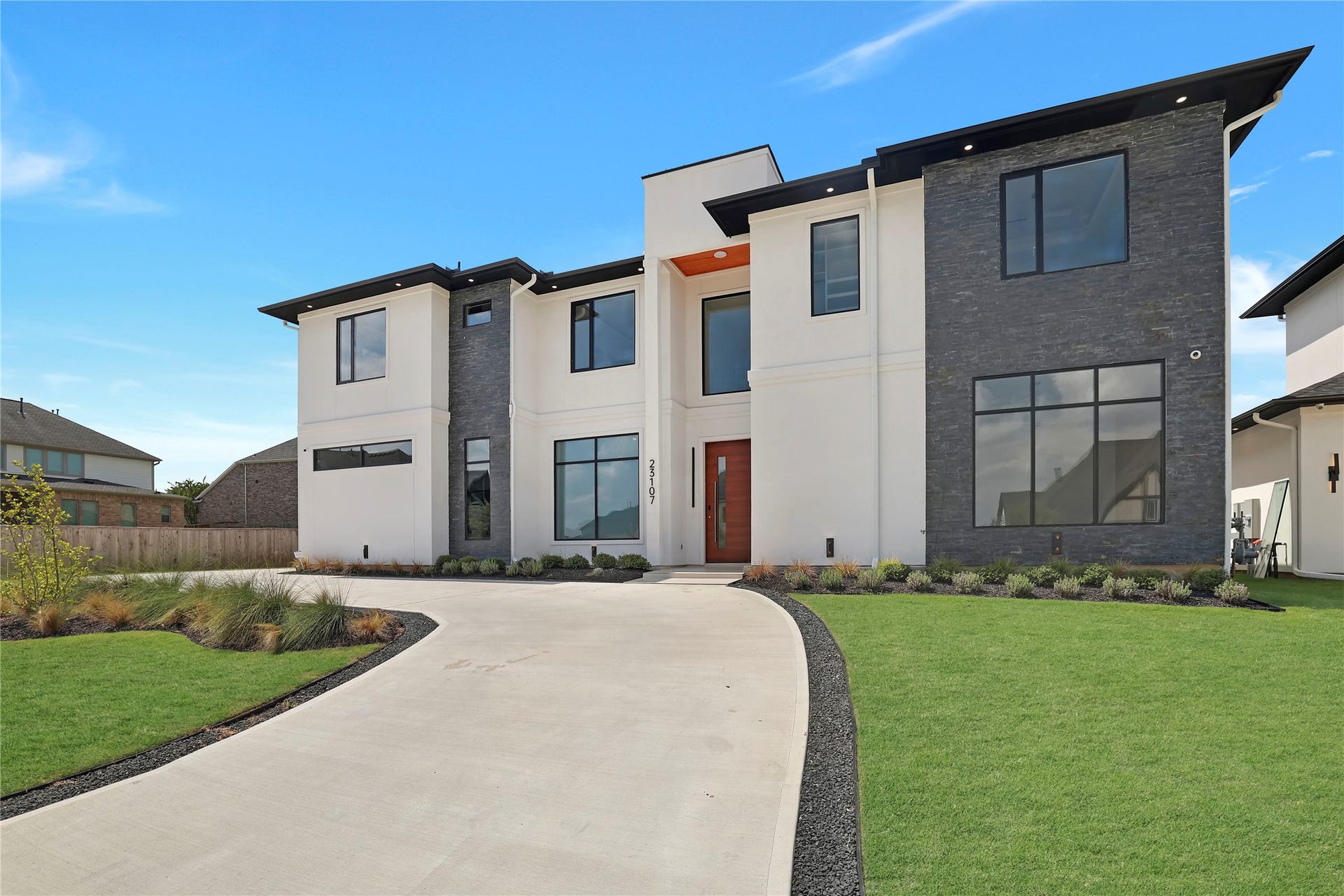 Another look at your new home's stunning elevation and circular driveway, offering generous parking for family and friends.