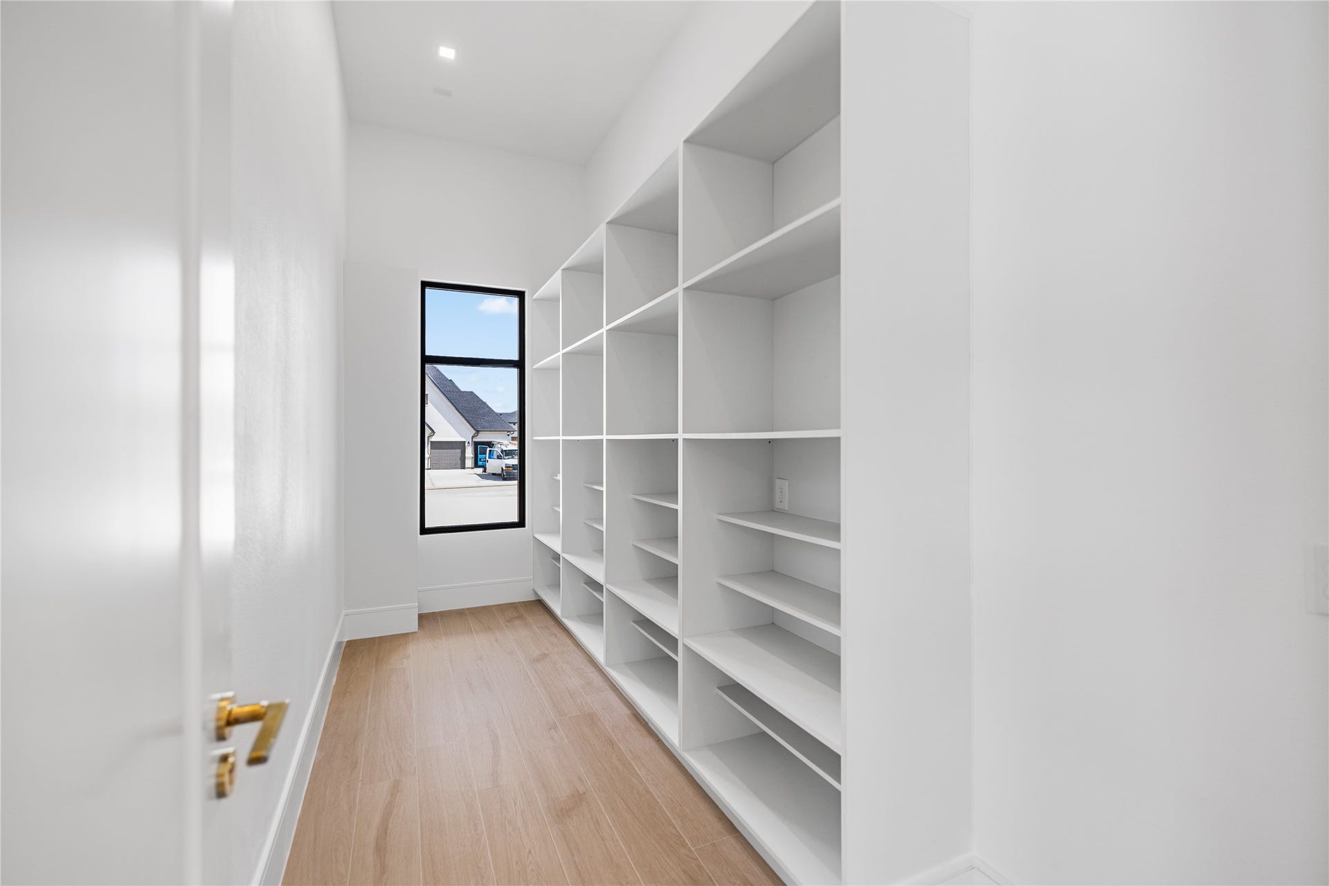 Located just behind the kitchen, a truly Texas-sized first-floor walk-in pantry, outfitted with exceptional built-in storage.