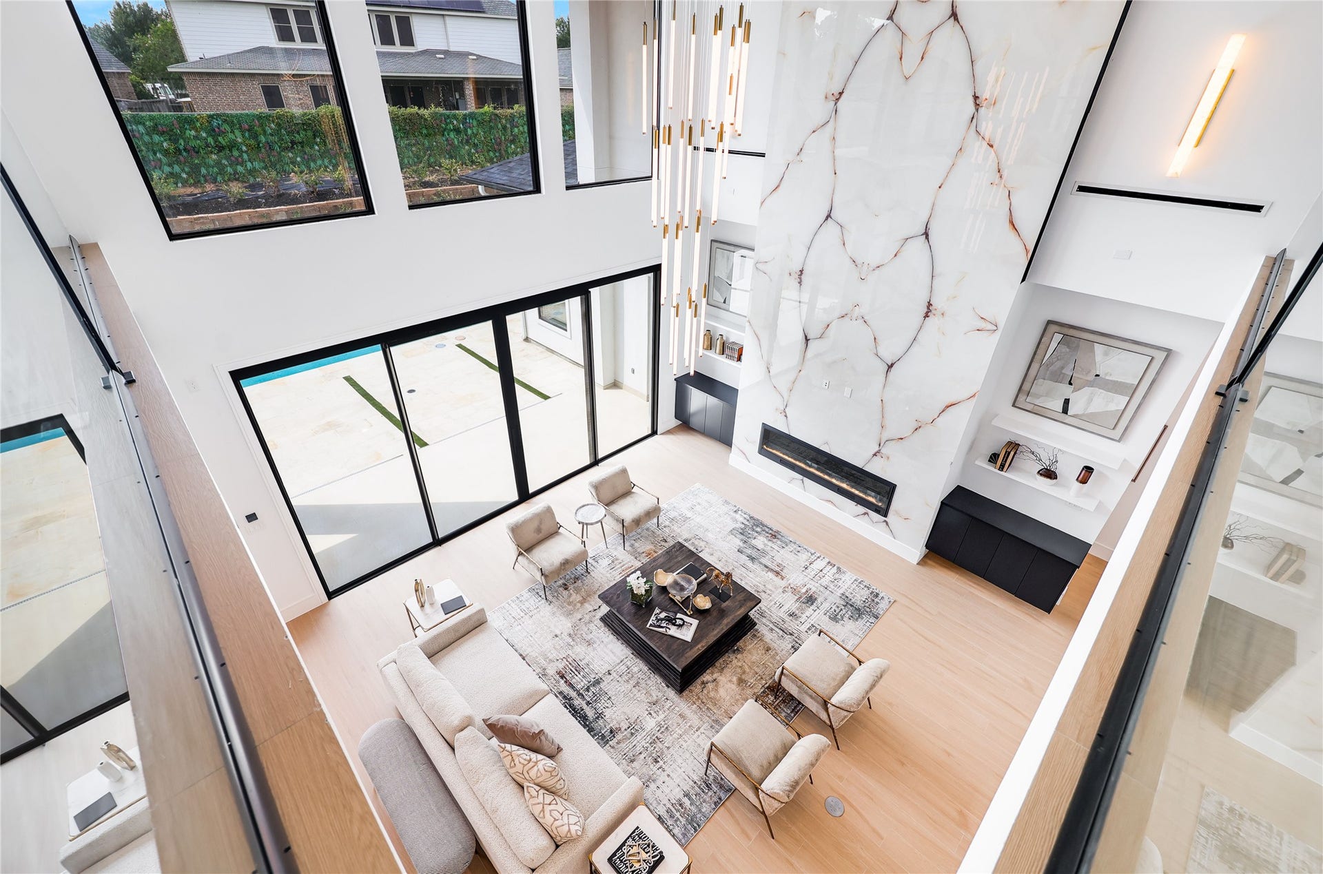 Upstairs, the elegant hallways overlook the grandeur of the living spaces below.