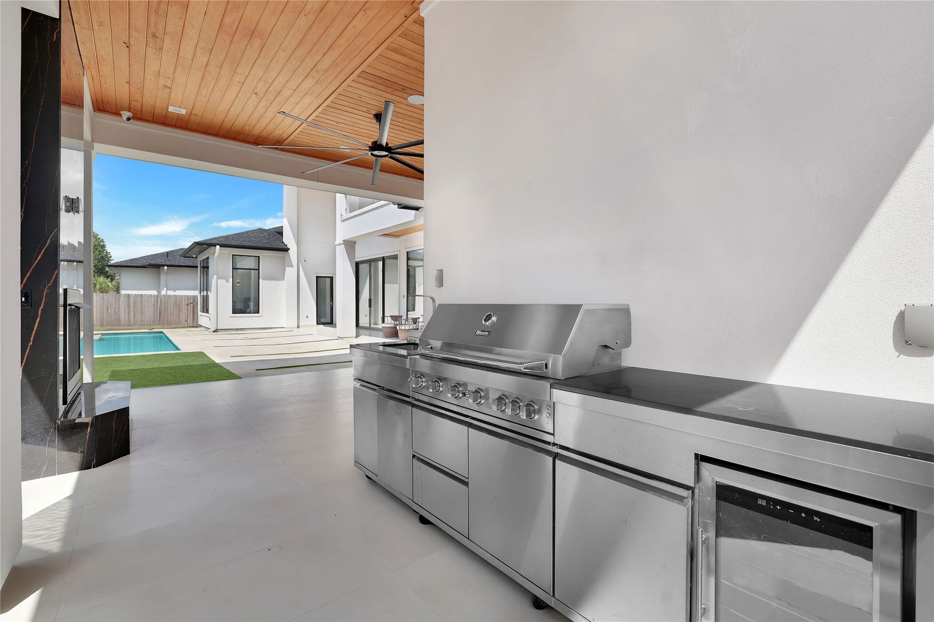 An outdoor kitchen designed for memorable cookouts and effortless entertaining with a private pool bath conveniently located just beyond the adjoining wall.